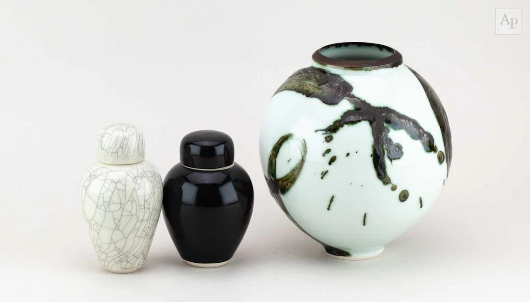 TRICIA THOM; a globular porcelain jar covered in celadon...