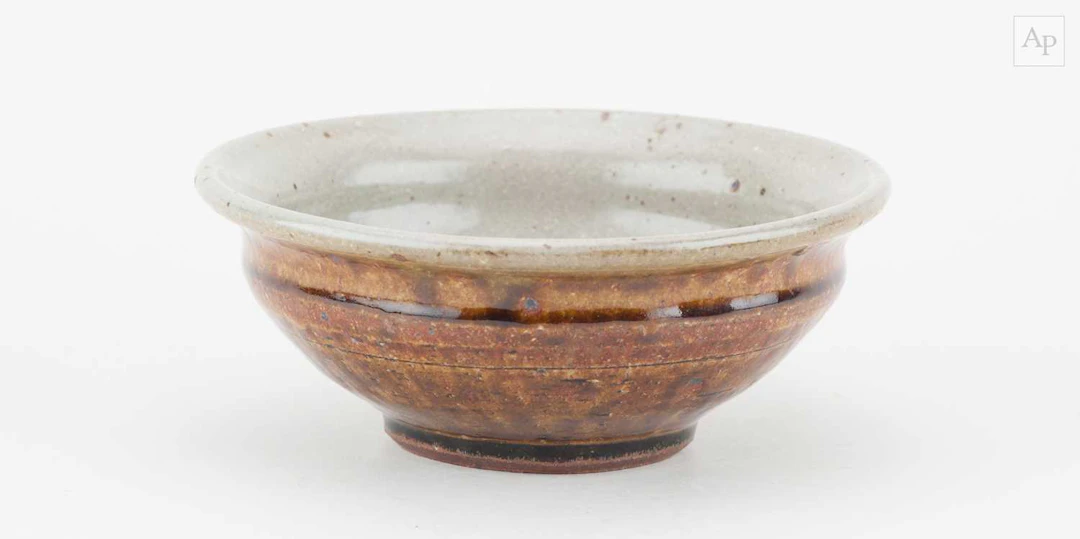 MIKE DODD (born 1943); a stoneware bowl covered in...