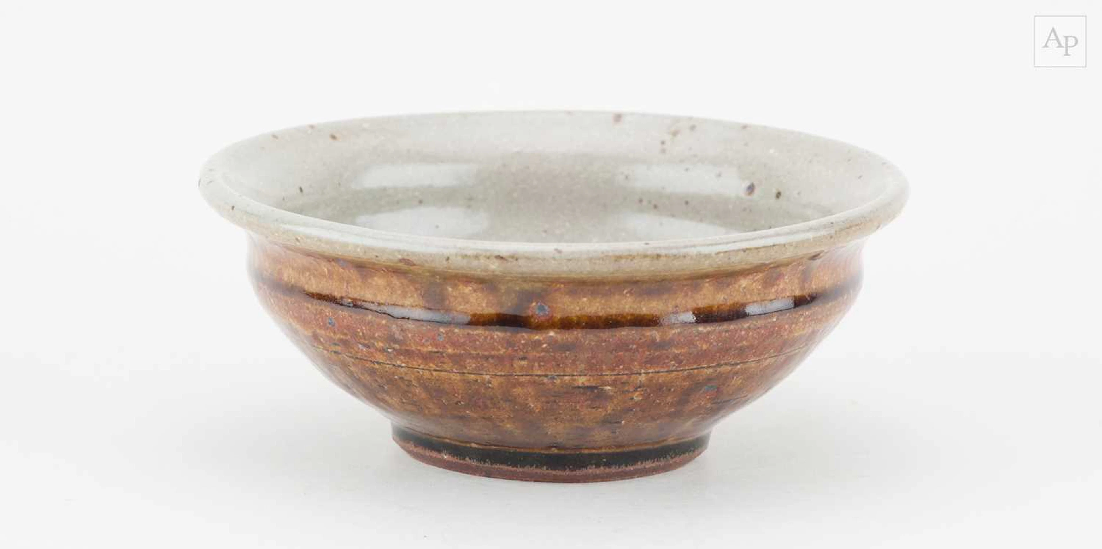 MIKE DODD (born 1943); a stoneware bowl covered in...