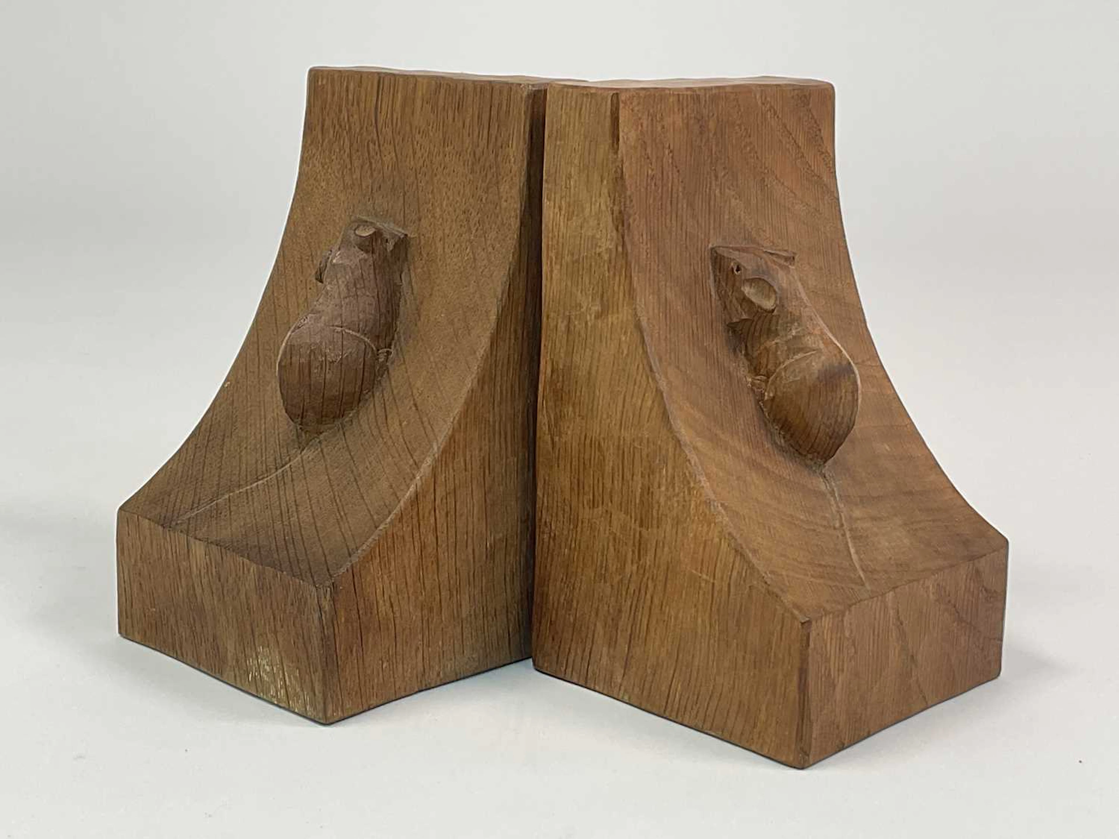 WORKSHOP OF ROBERT 'MOUSEMAN' THOMPSON; a near pair of oak bookends
