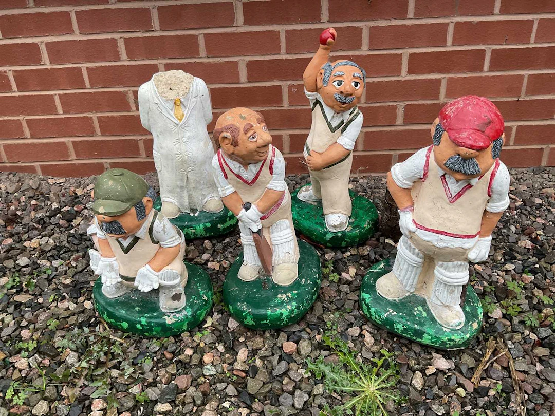 Five painted composite stone cricketing garden ornaments