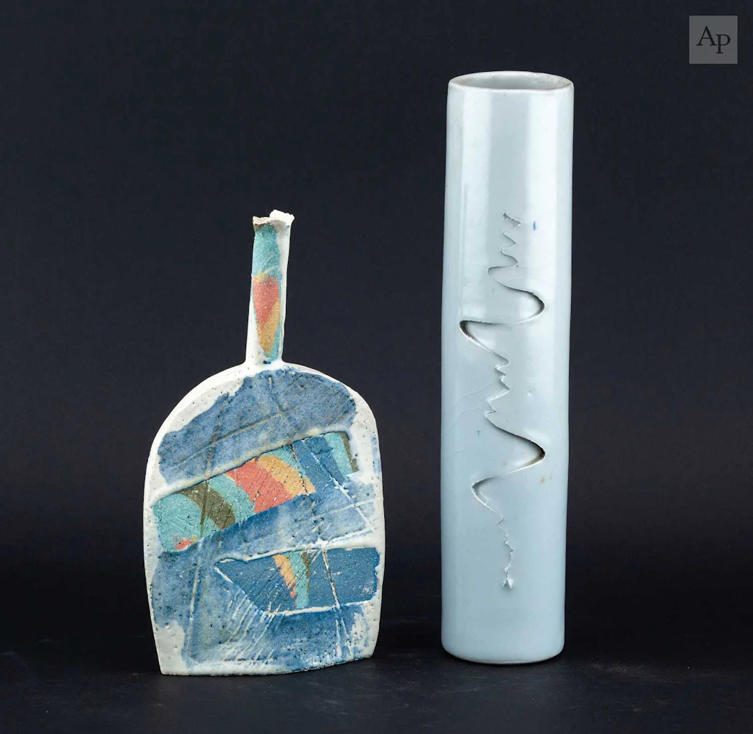 NINA CLARK; a tall cylindrical porcelain vase covered in...