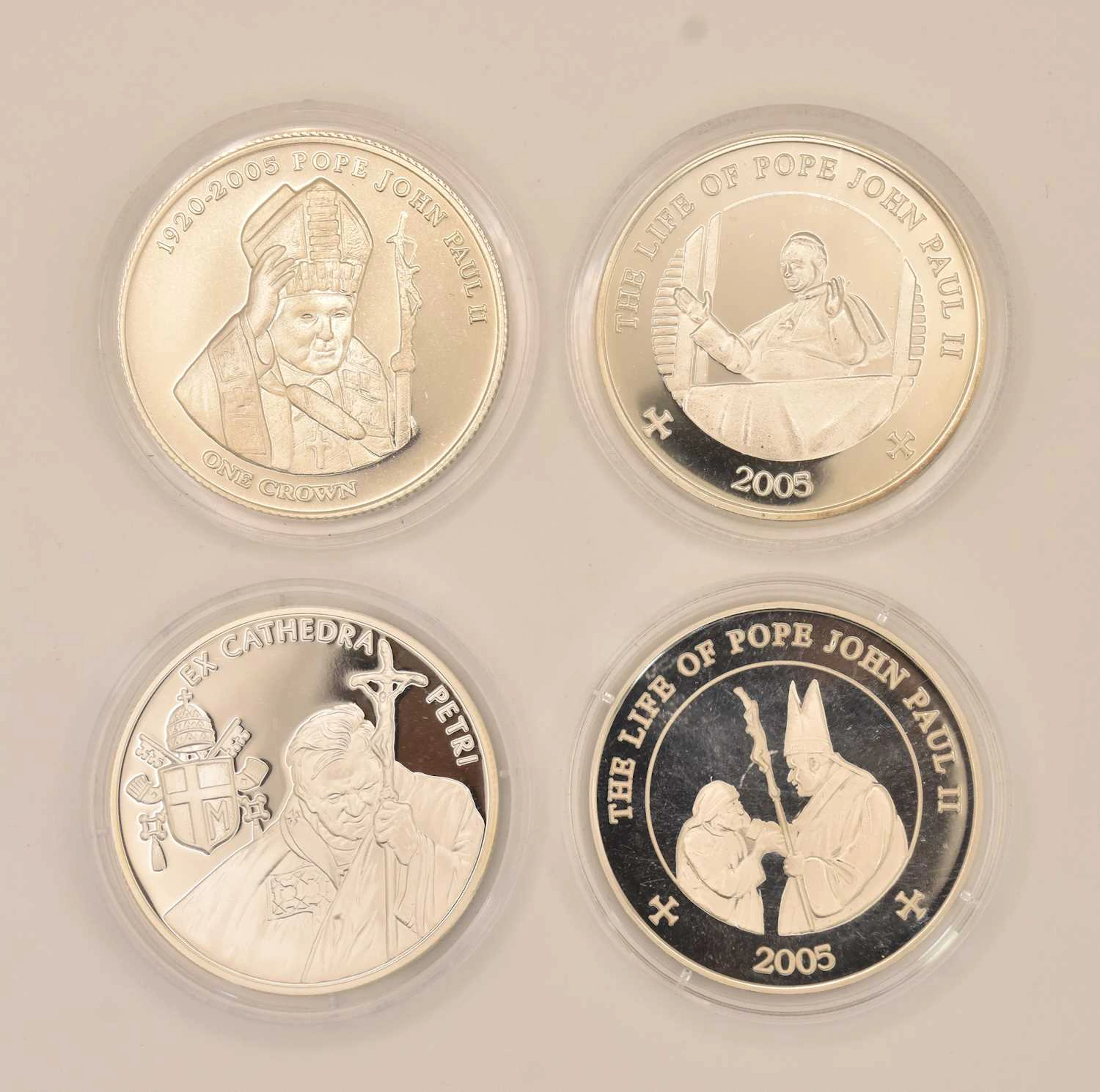 Four encapsulated silver proof coins