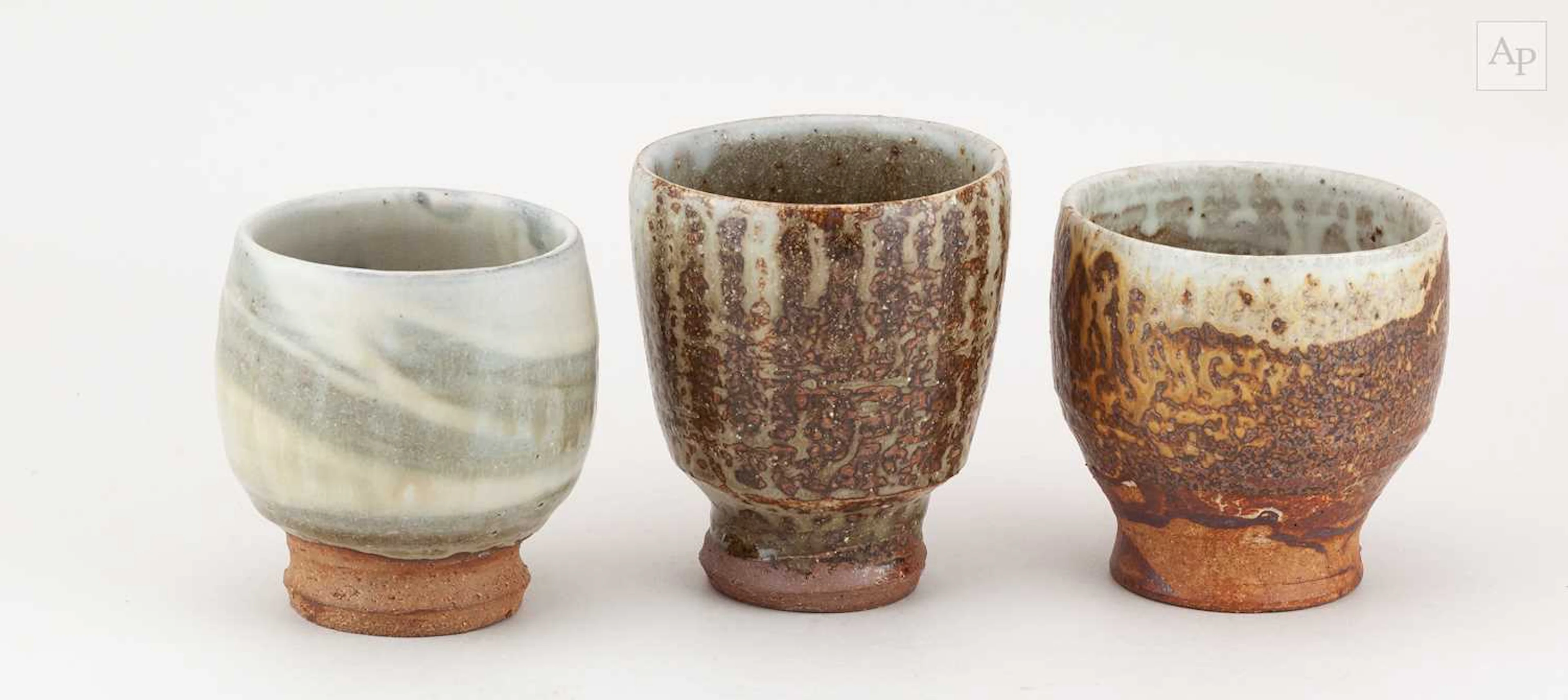 TIM LAKE (born 1974); a trio of stoneware cups covered in different ash glazes