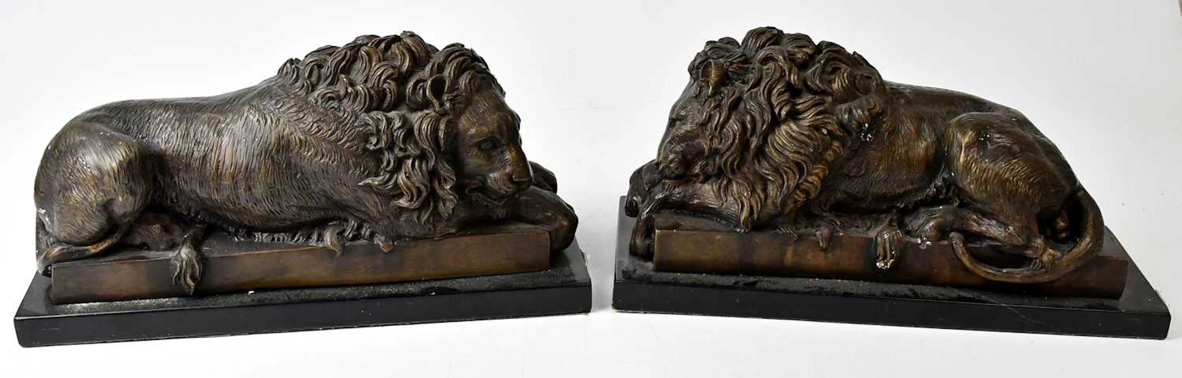 AFTER ANTONIO CANOVA; a pair of bronze models of recumbent 'Chatsworth' lions