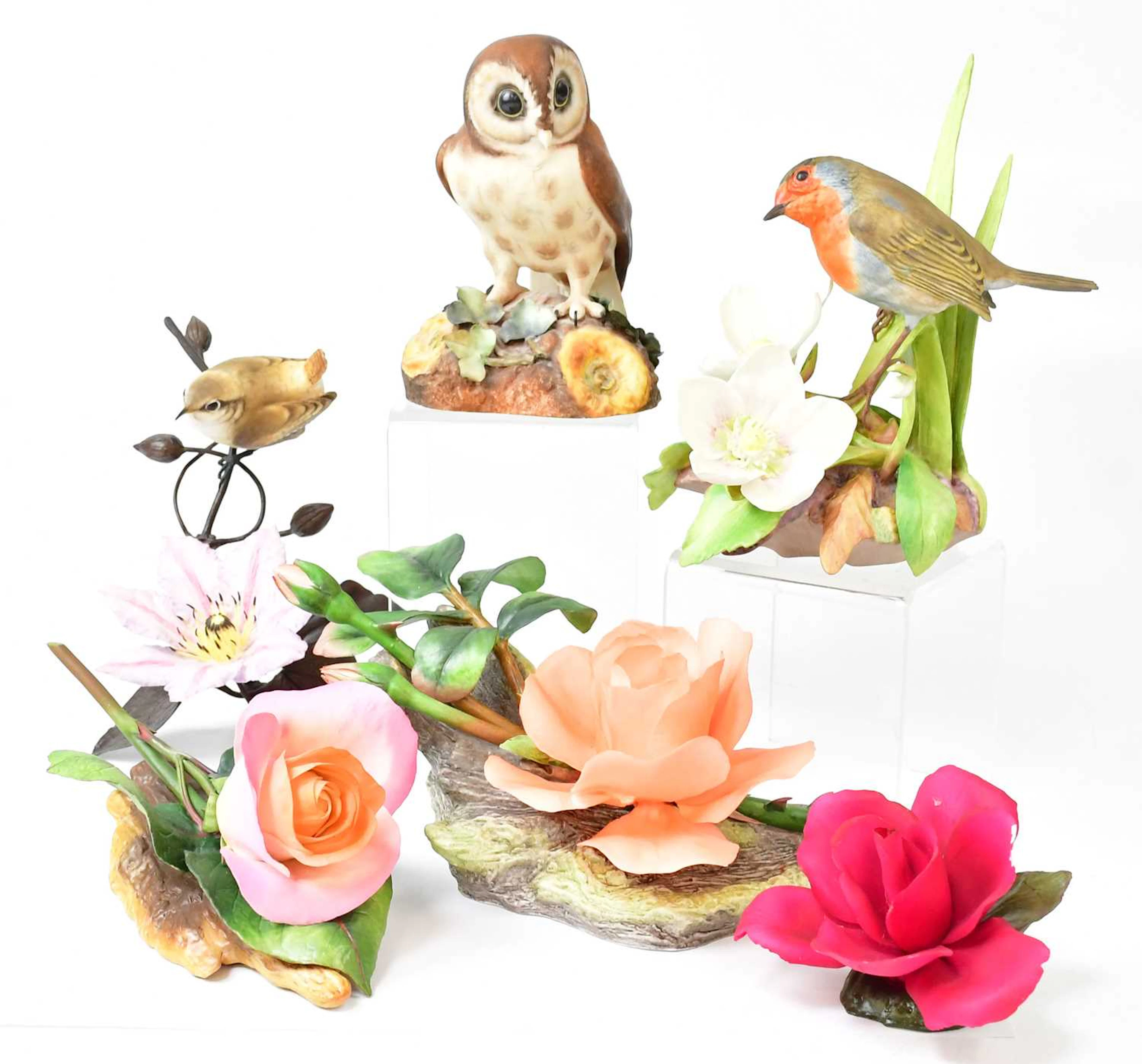 A collection of porcelain flowers and animals