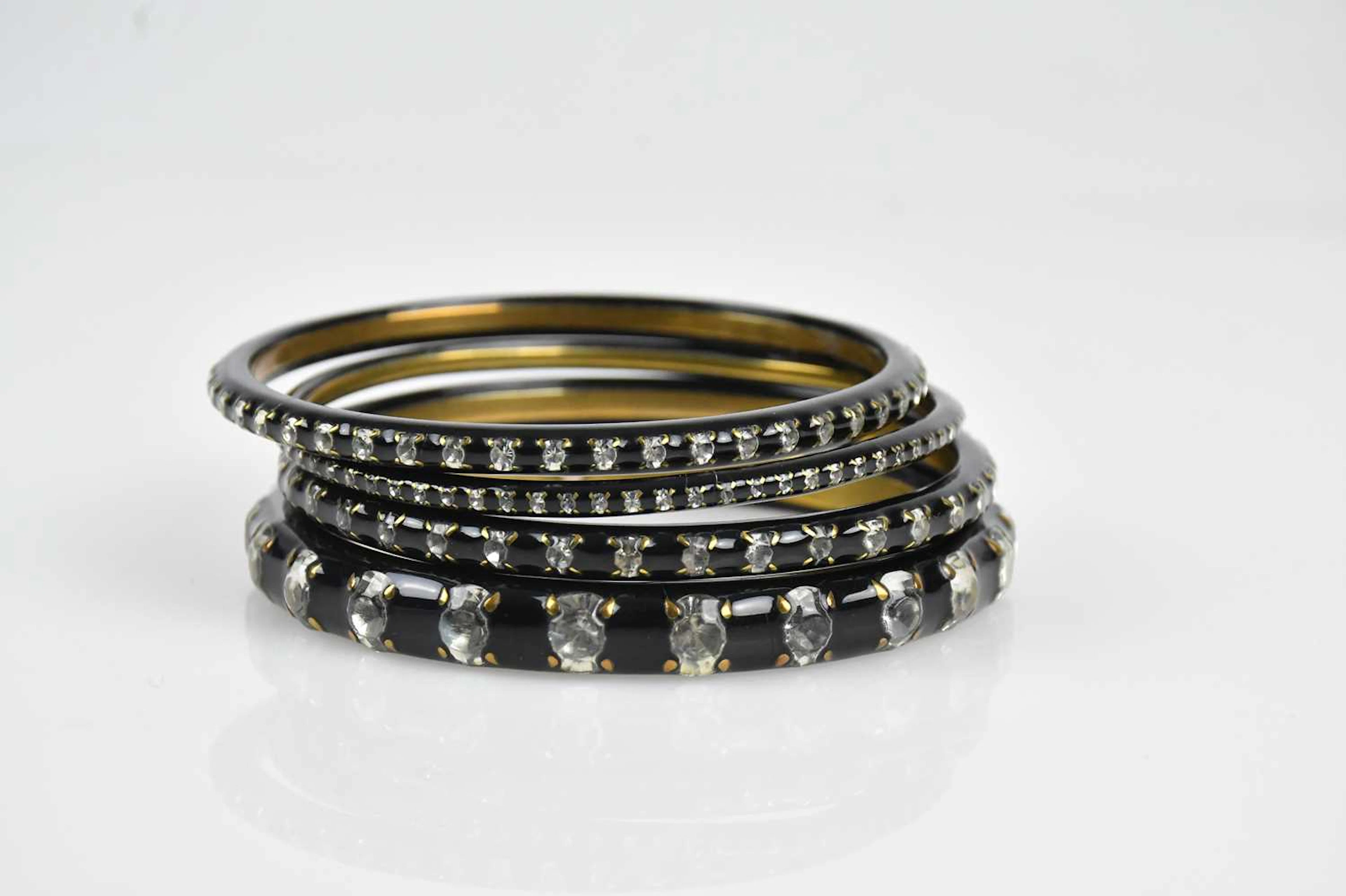 CHANEL; a set of four gold tone bangles