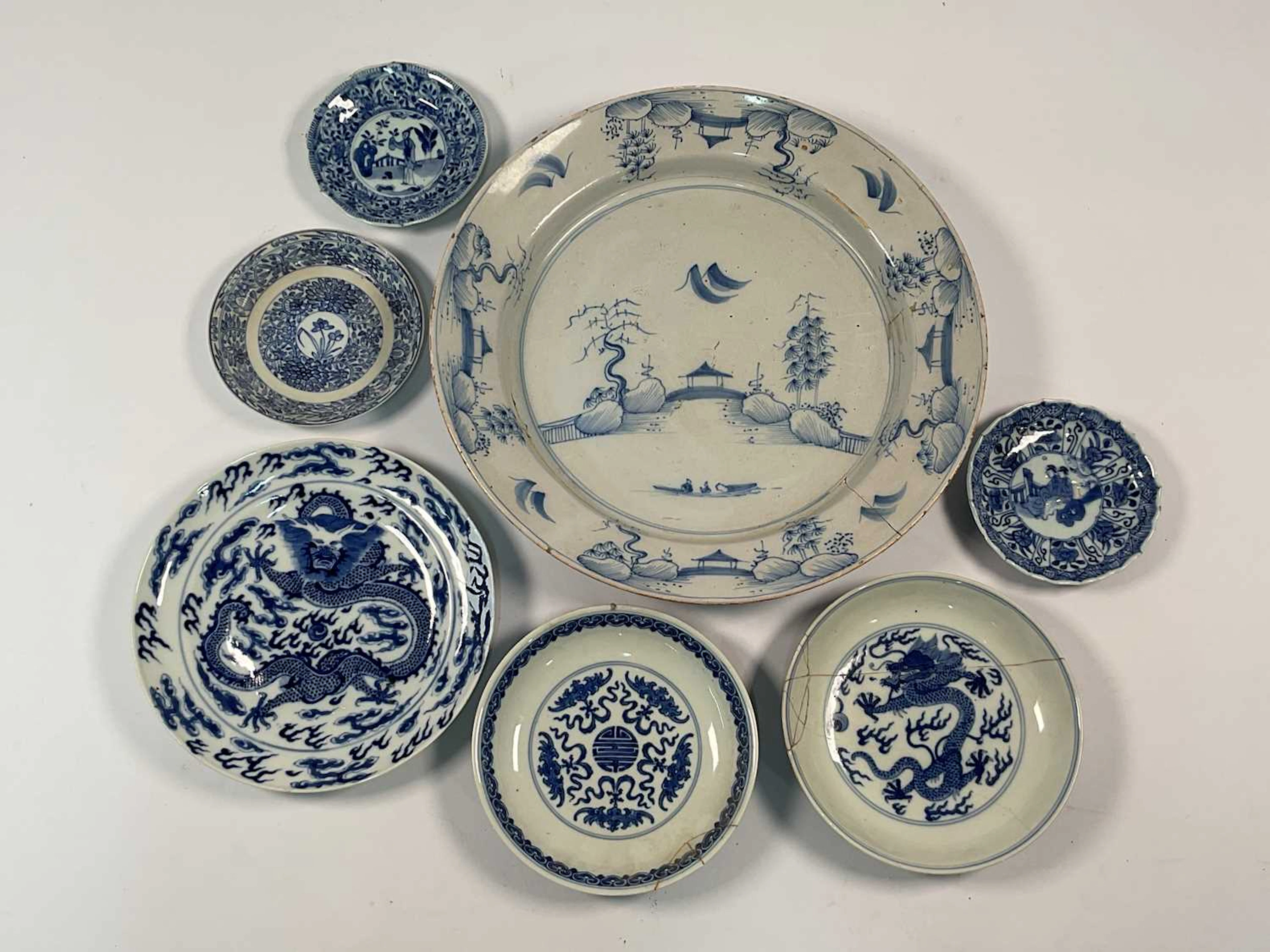 A Chinese blue and white dish depicting a landscape with a bridge