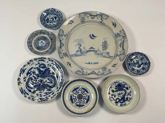 A Chinese blue and white dish depicting a landscape with a bridge