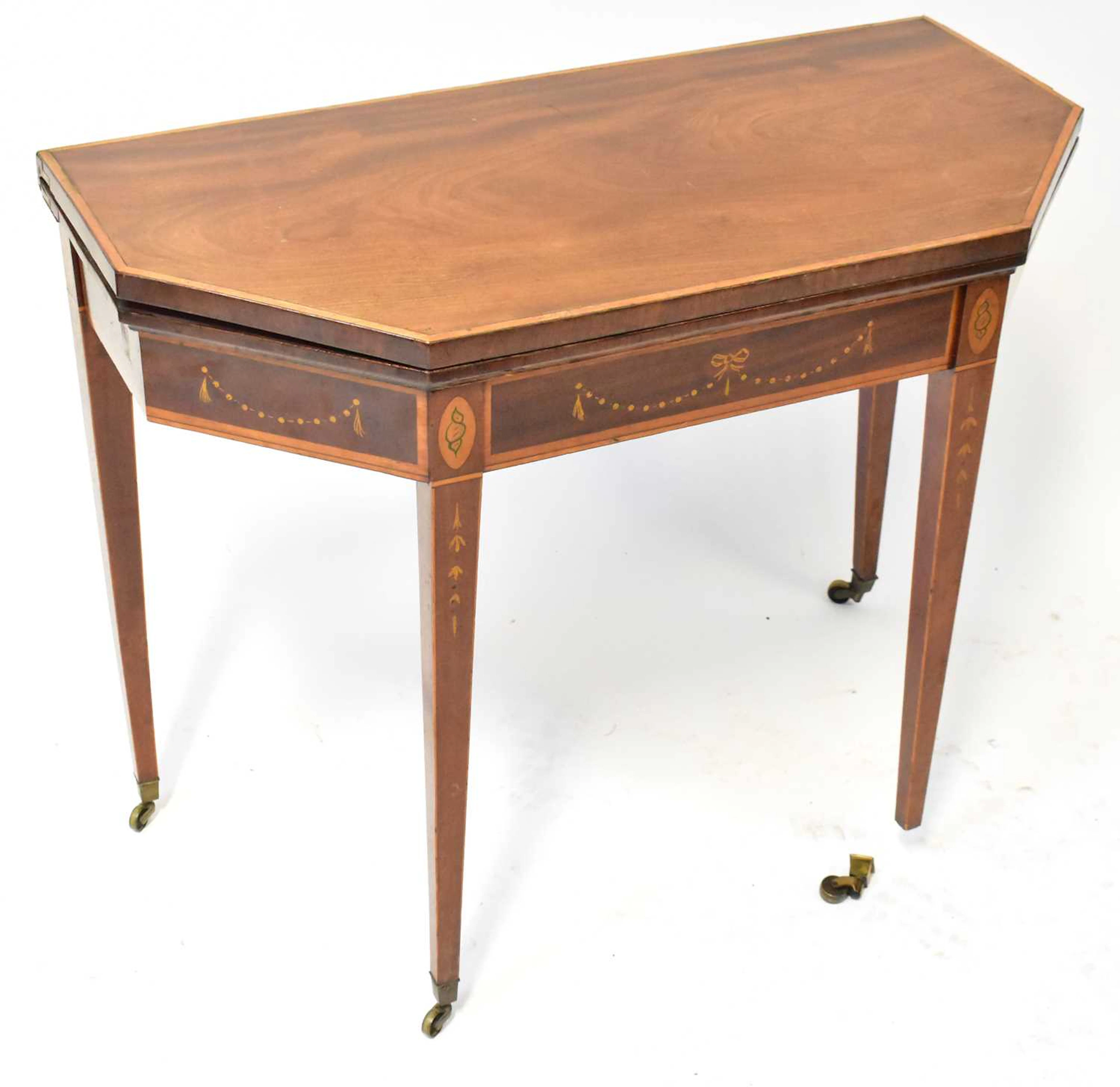 An early 19th century inlaid mahogany card table