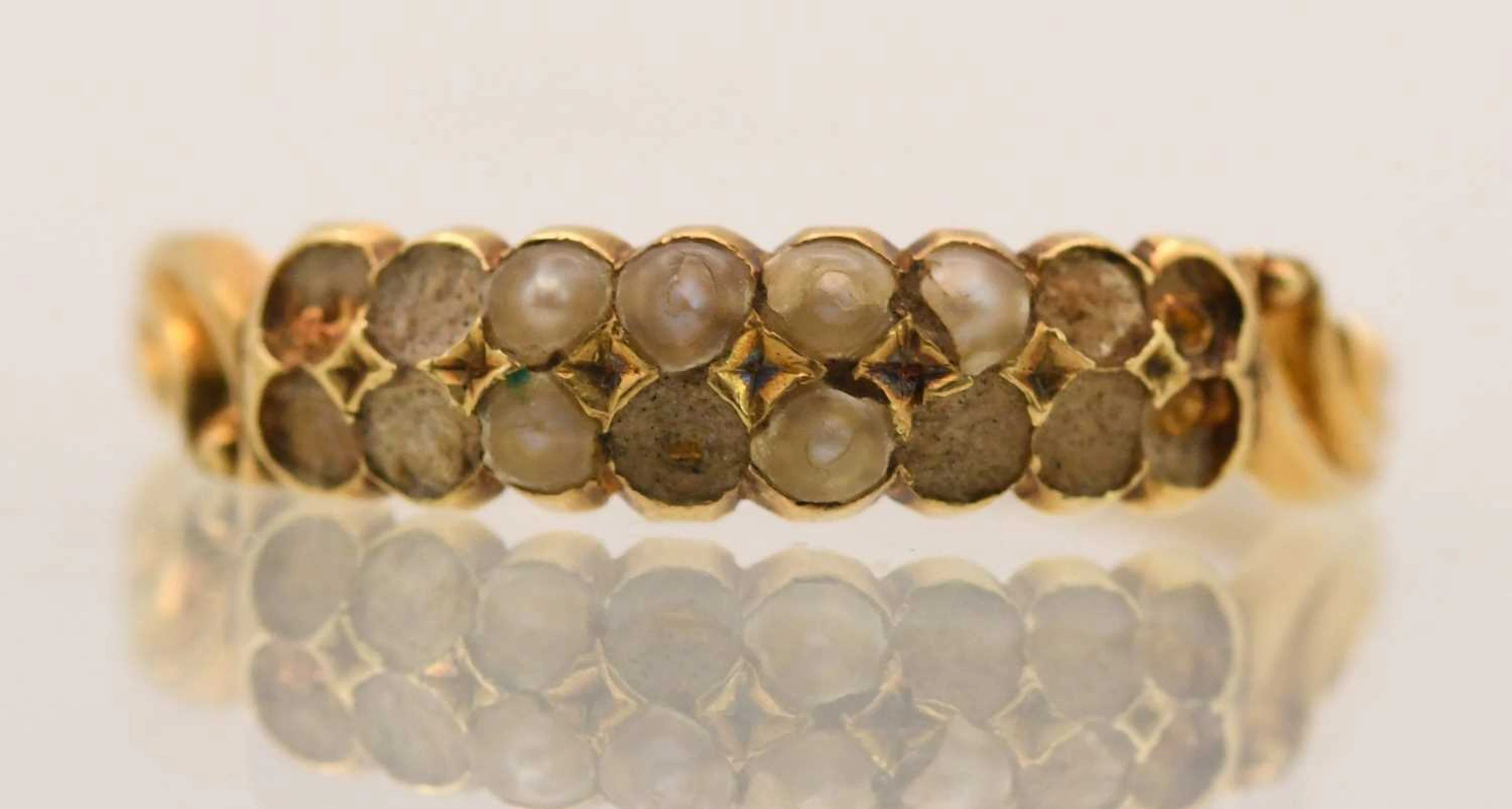 A 9ct yellow gold seed pearl set dress ring