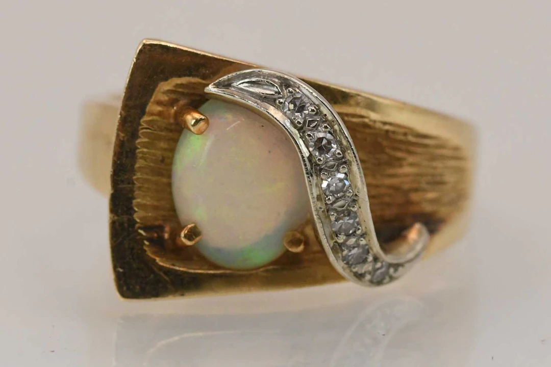 A 14k yellow gold opal and diamond set ring