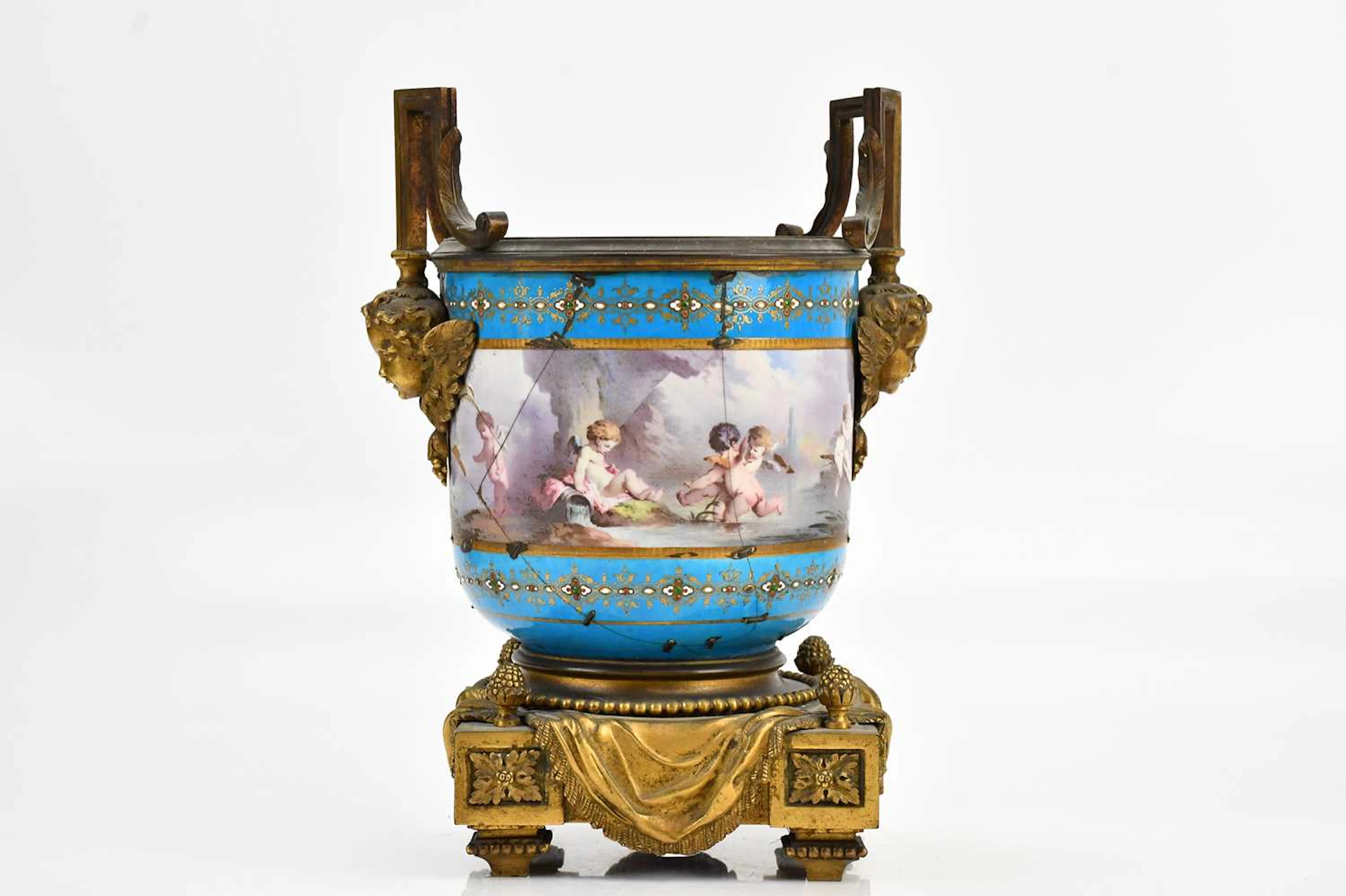 A late 19th century hand painted porcelain and ormolu twin handled planter
