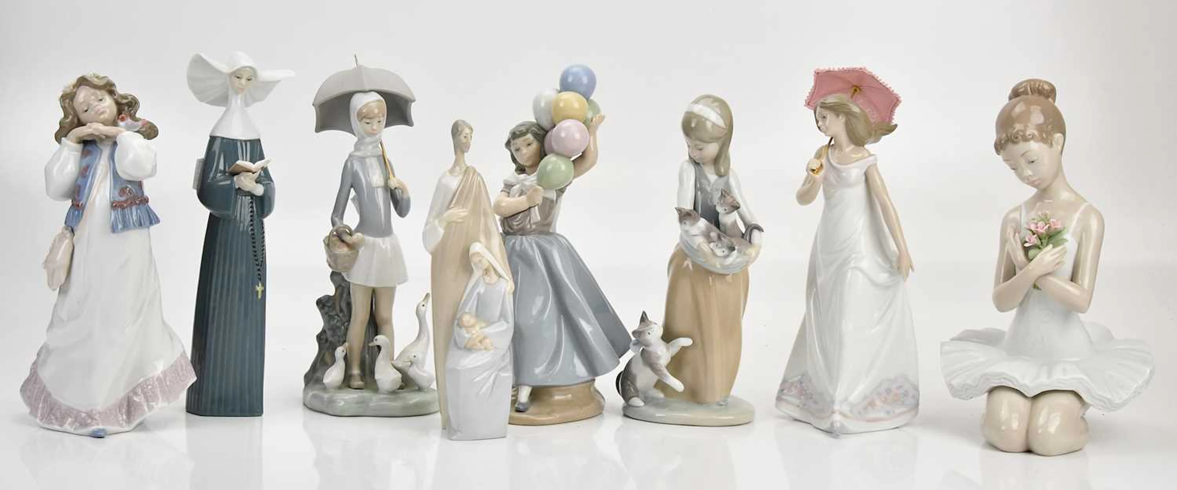 LLADRÓ; eight figures comprising two girls with parasols