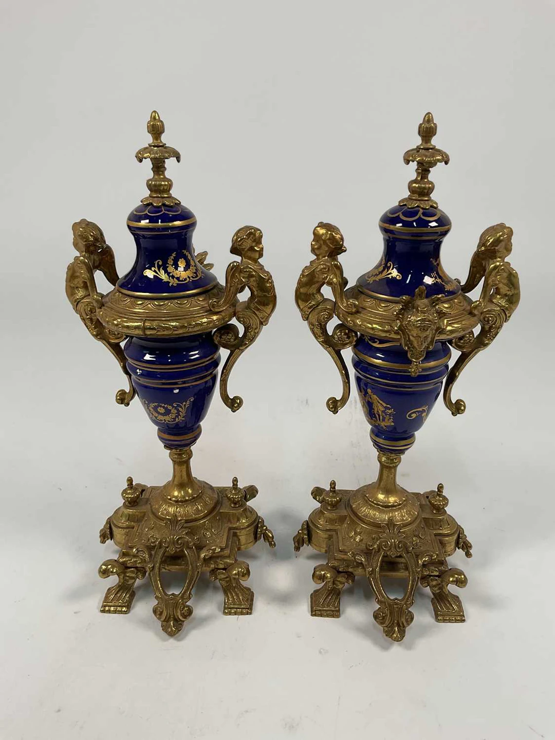 A pair of modern blue ceramic and brass garnitures