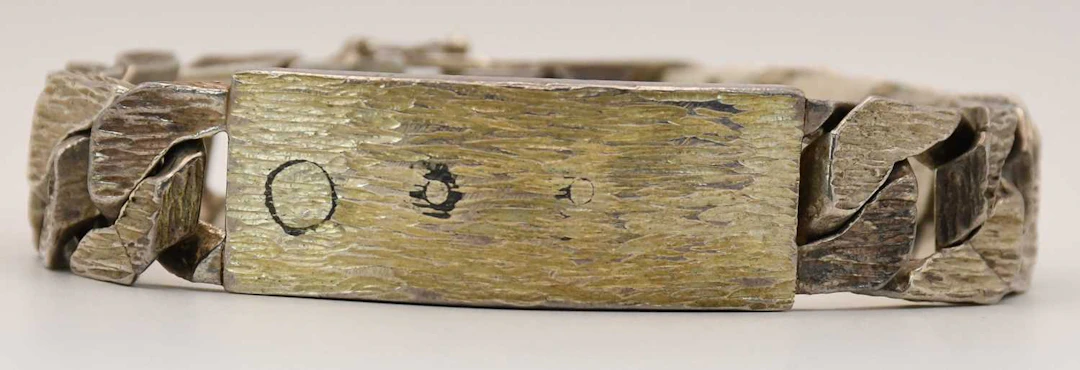 An Elizabeth II hallmarked silver flat Cuban link identity bracelet