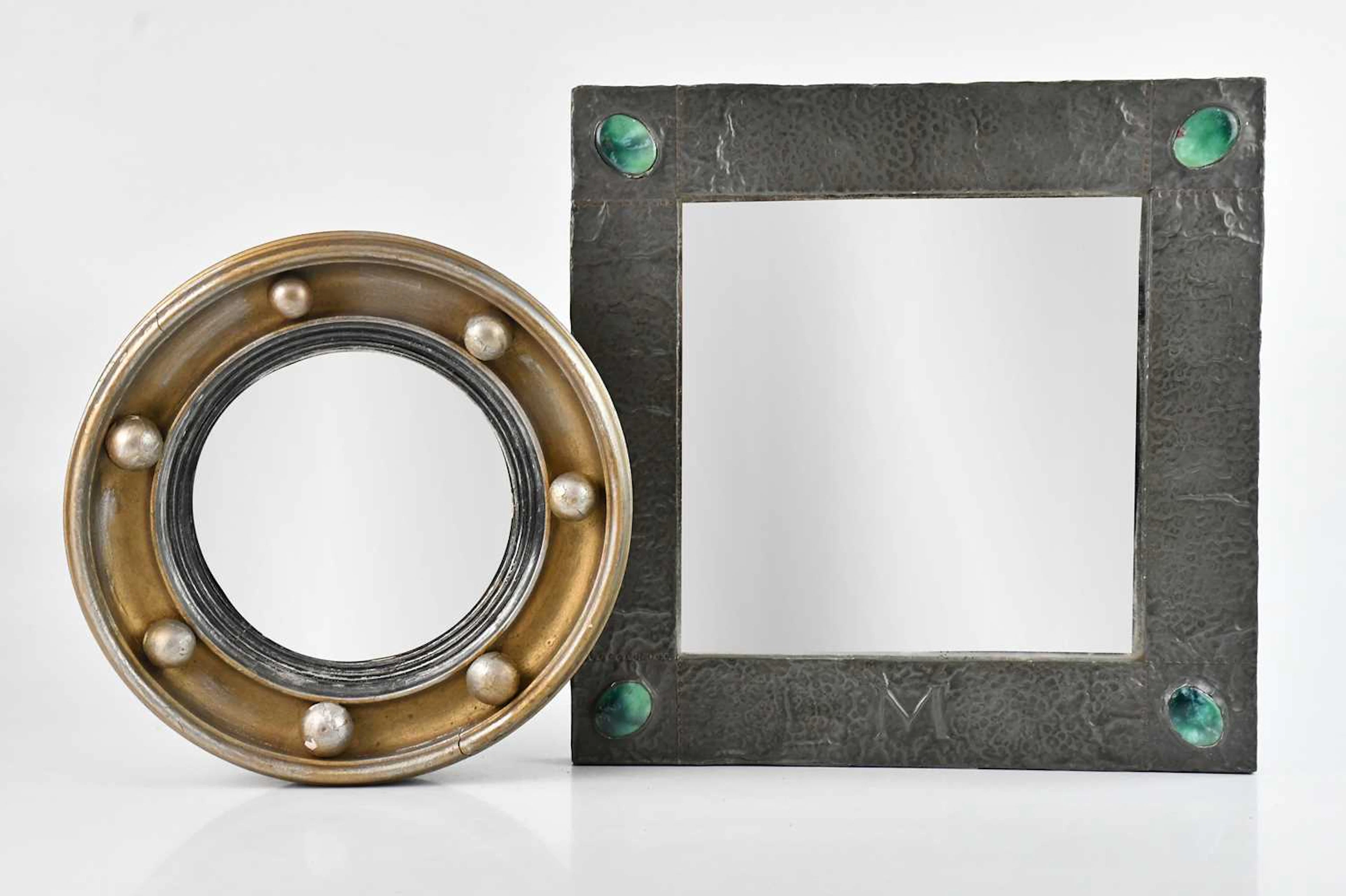 An Arts and Crafts sheet pewter square wall mirror set...