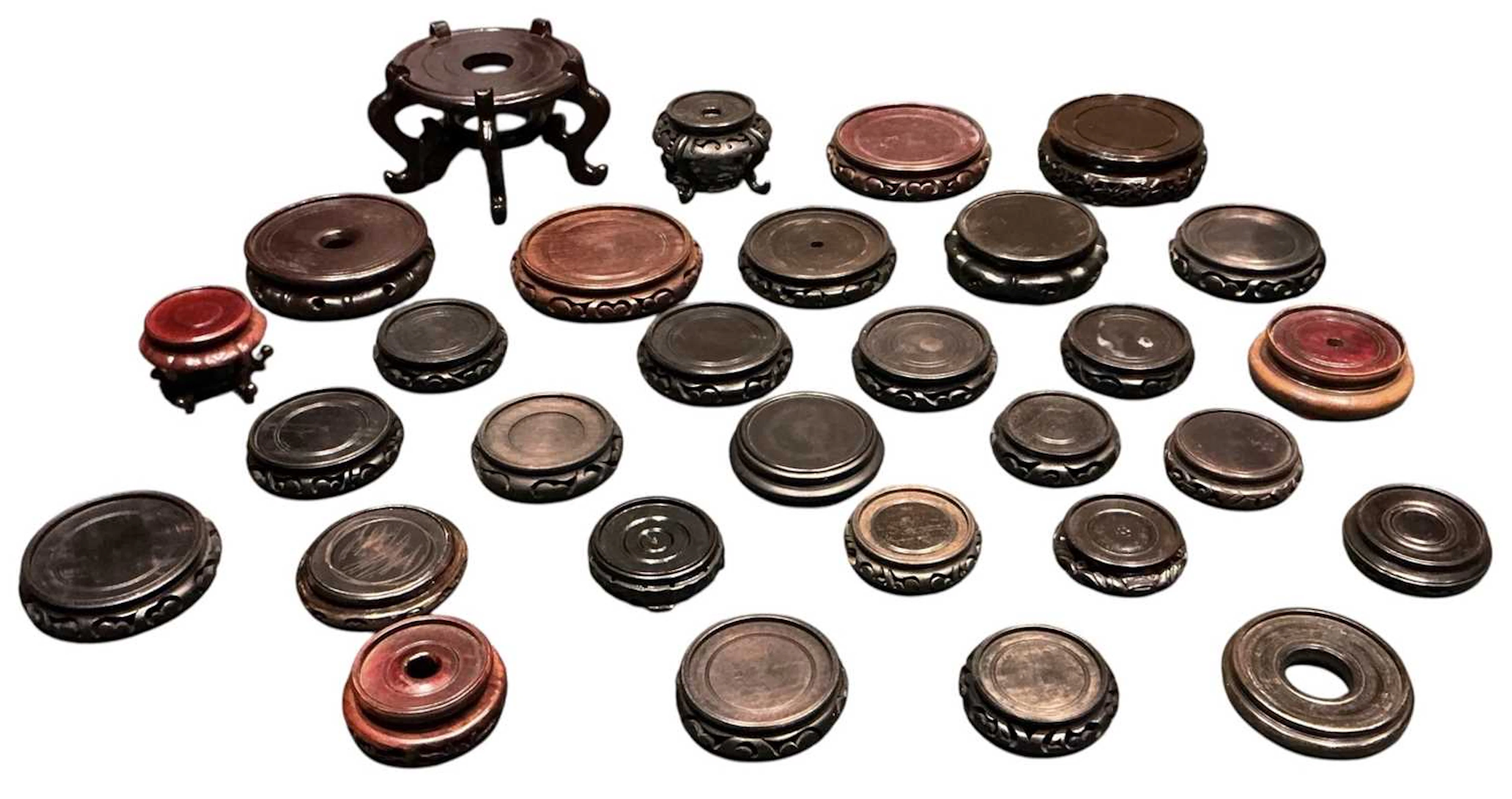 A collection of approximately twenty-nine Chinese carved hardwood stands