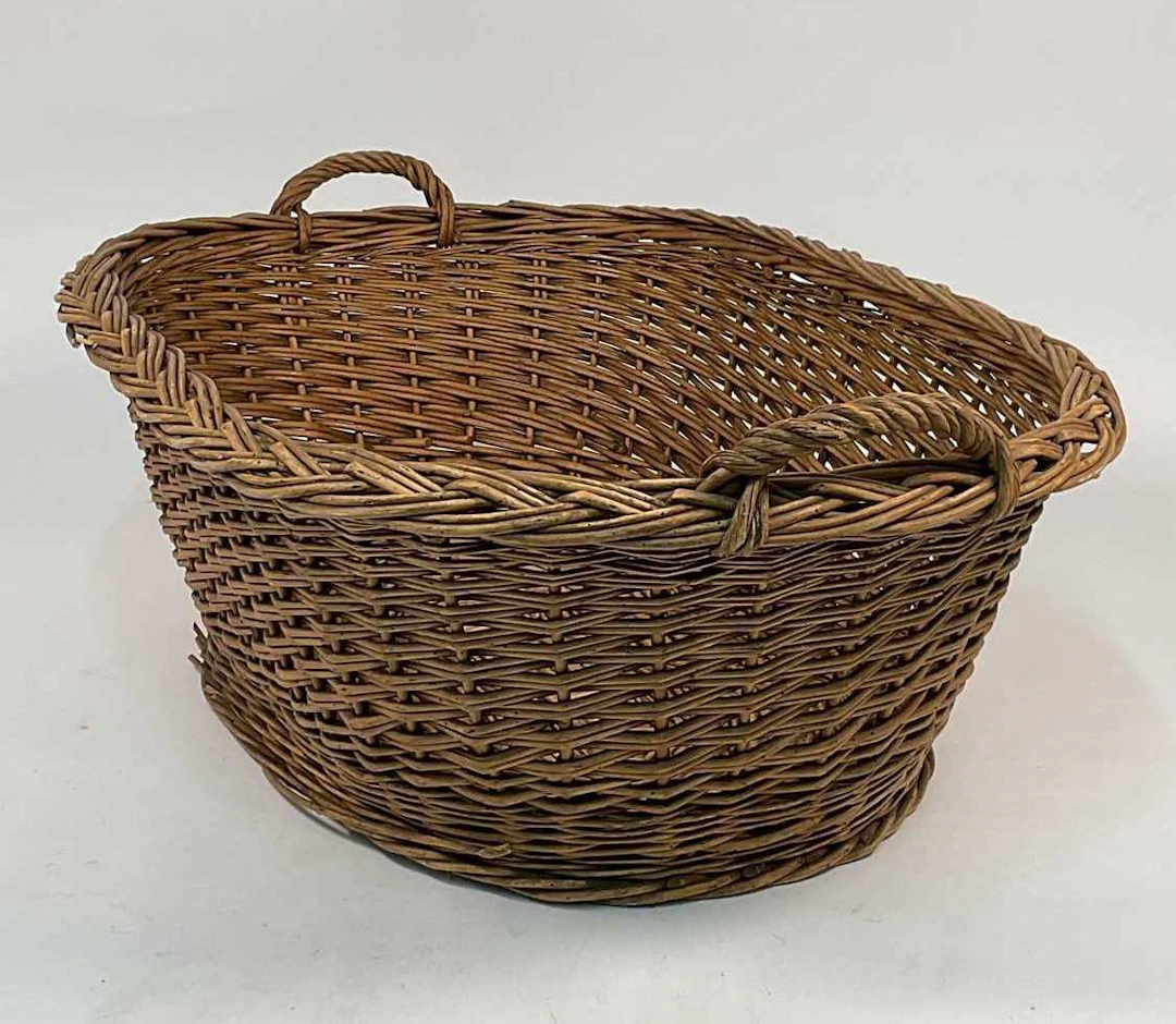 A large French roll top wicker basket