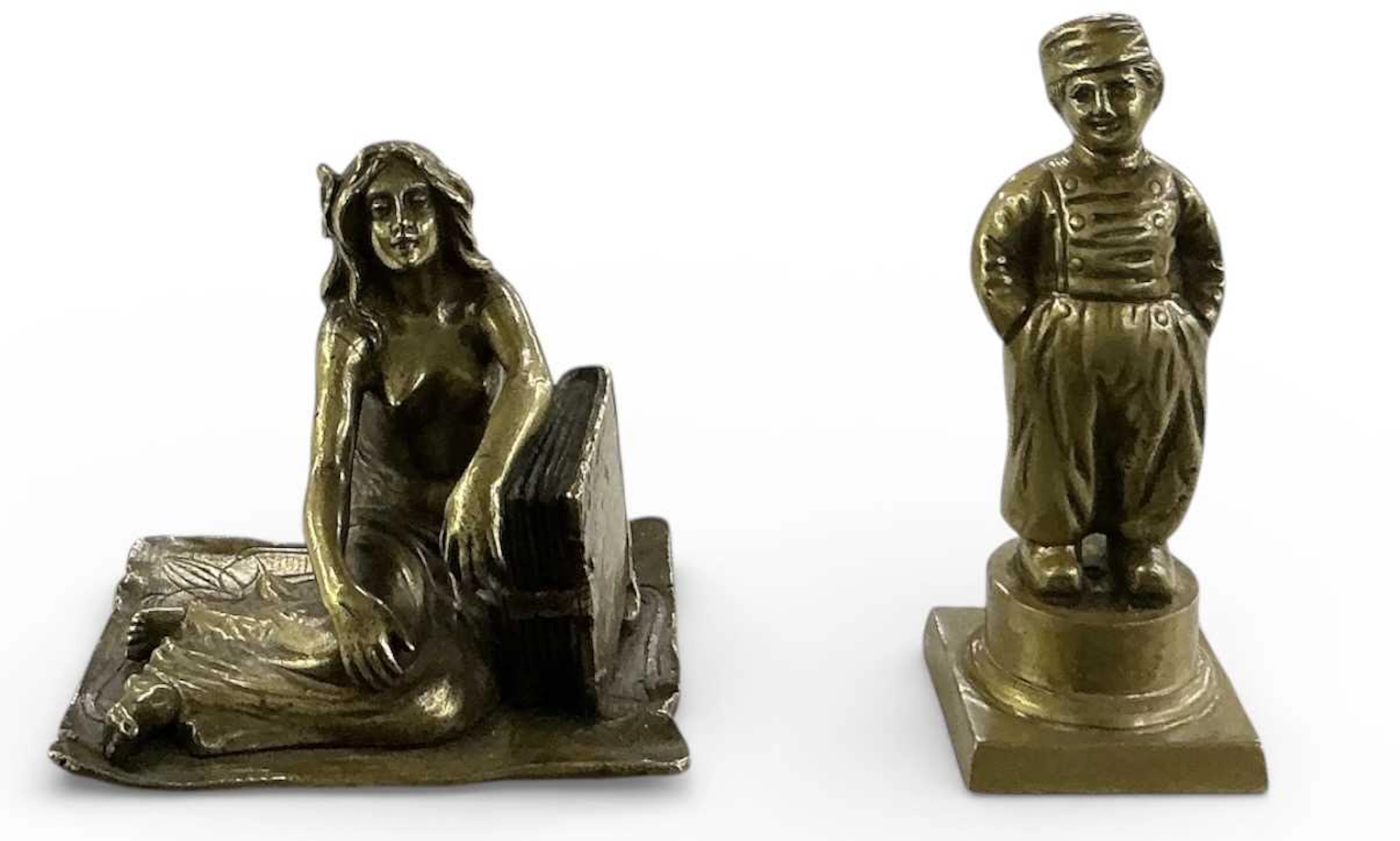 A small early 20th century bronze figure of a recumbent nude seated on a carpet