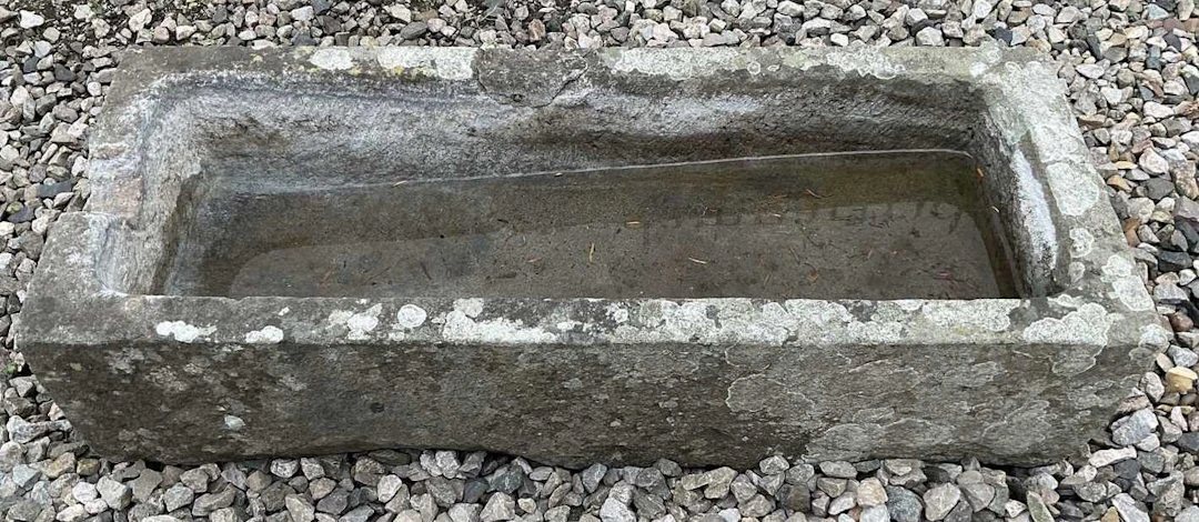 A composite stone water trough