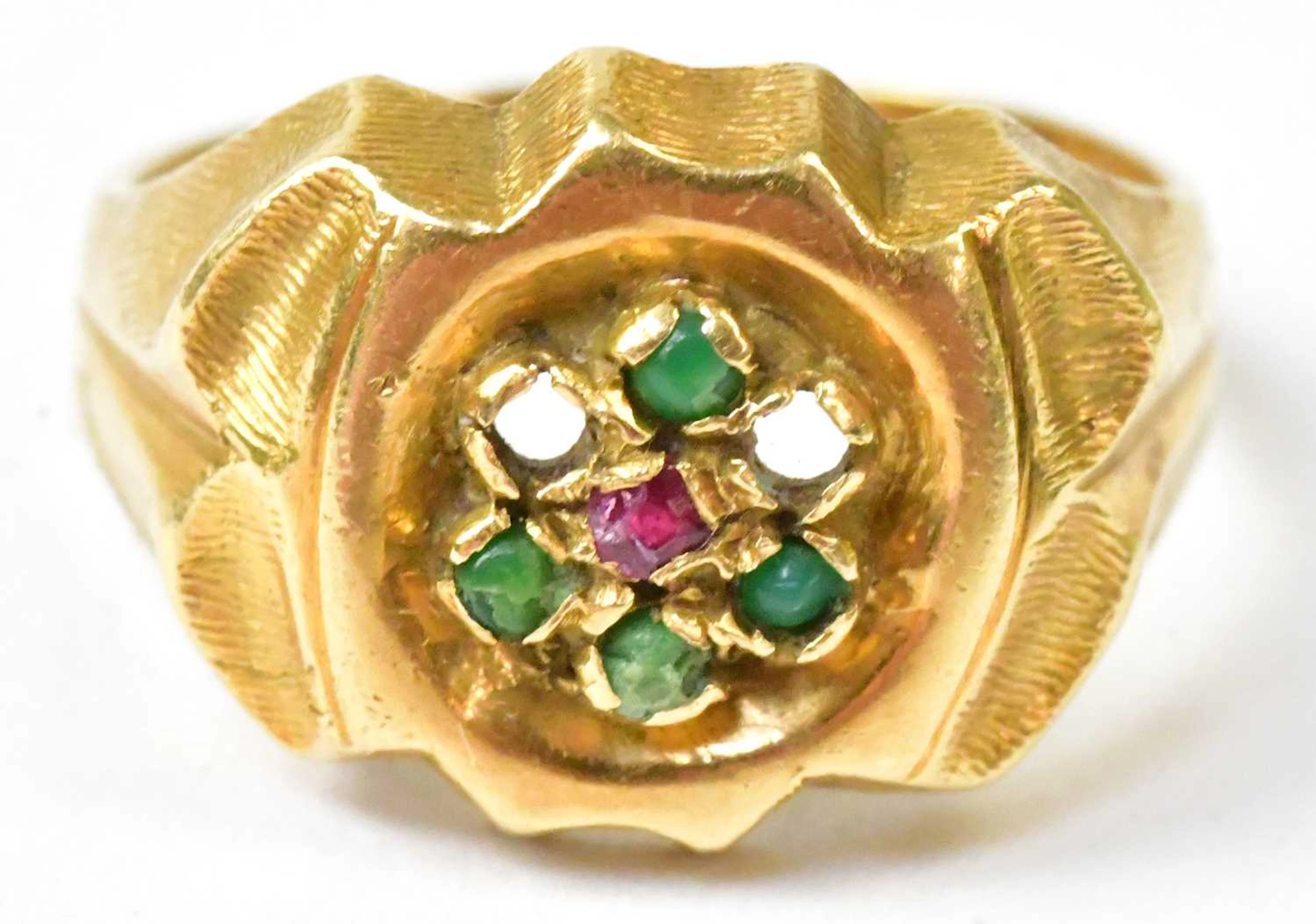 An 18ct yellow gold ring set with red and green stones (lacking two stones)