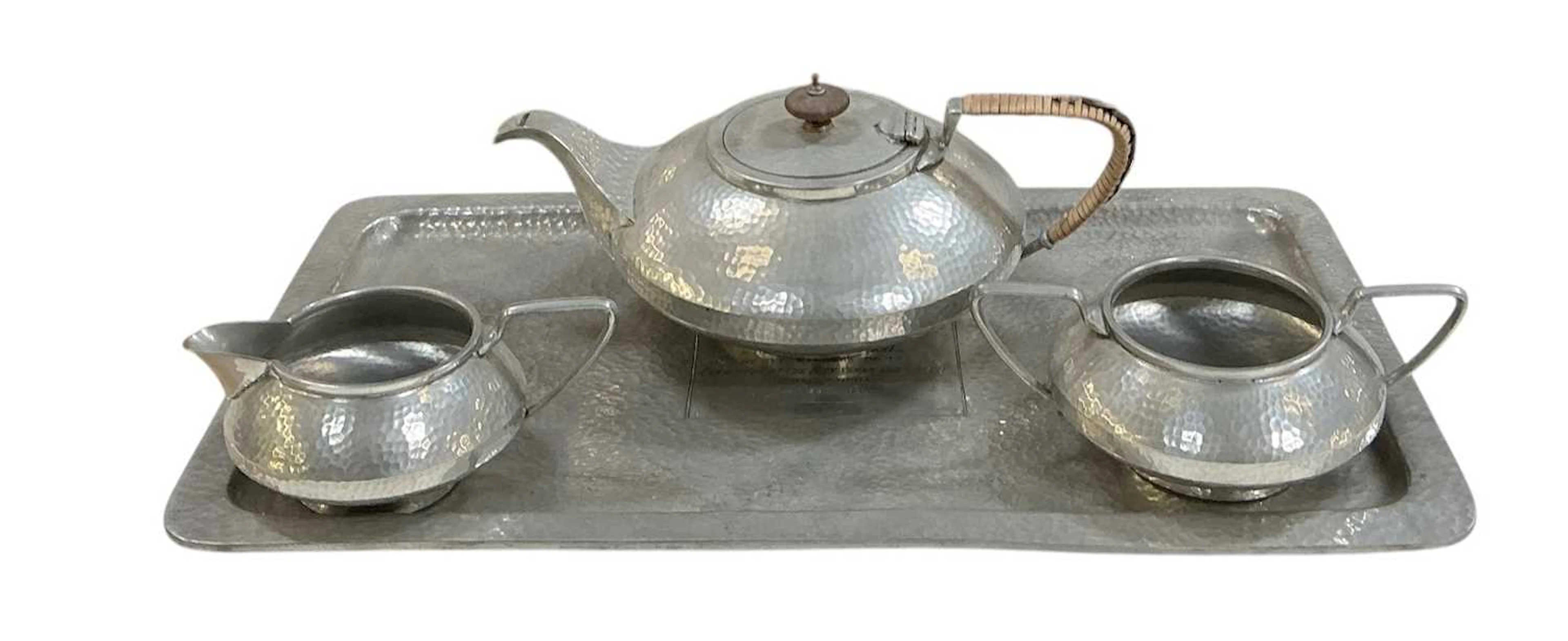An early 20th century Art Nouveau hammered pewter three...