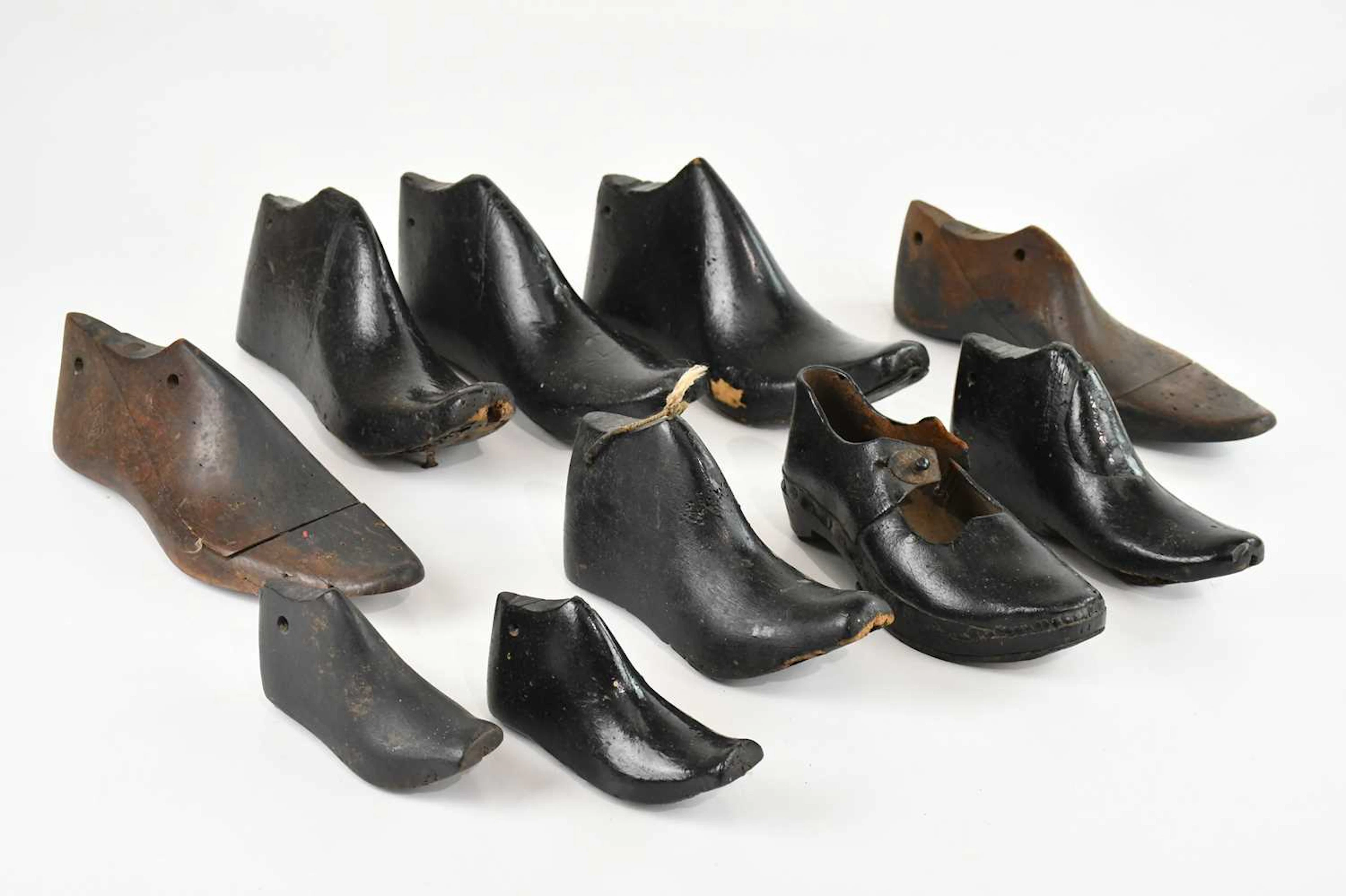 A collection of vintage shoe lasts and a vintage Victorian clock