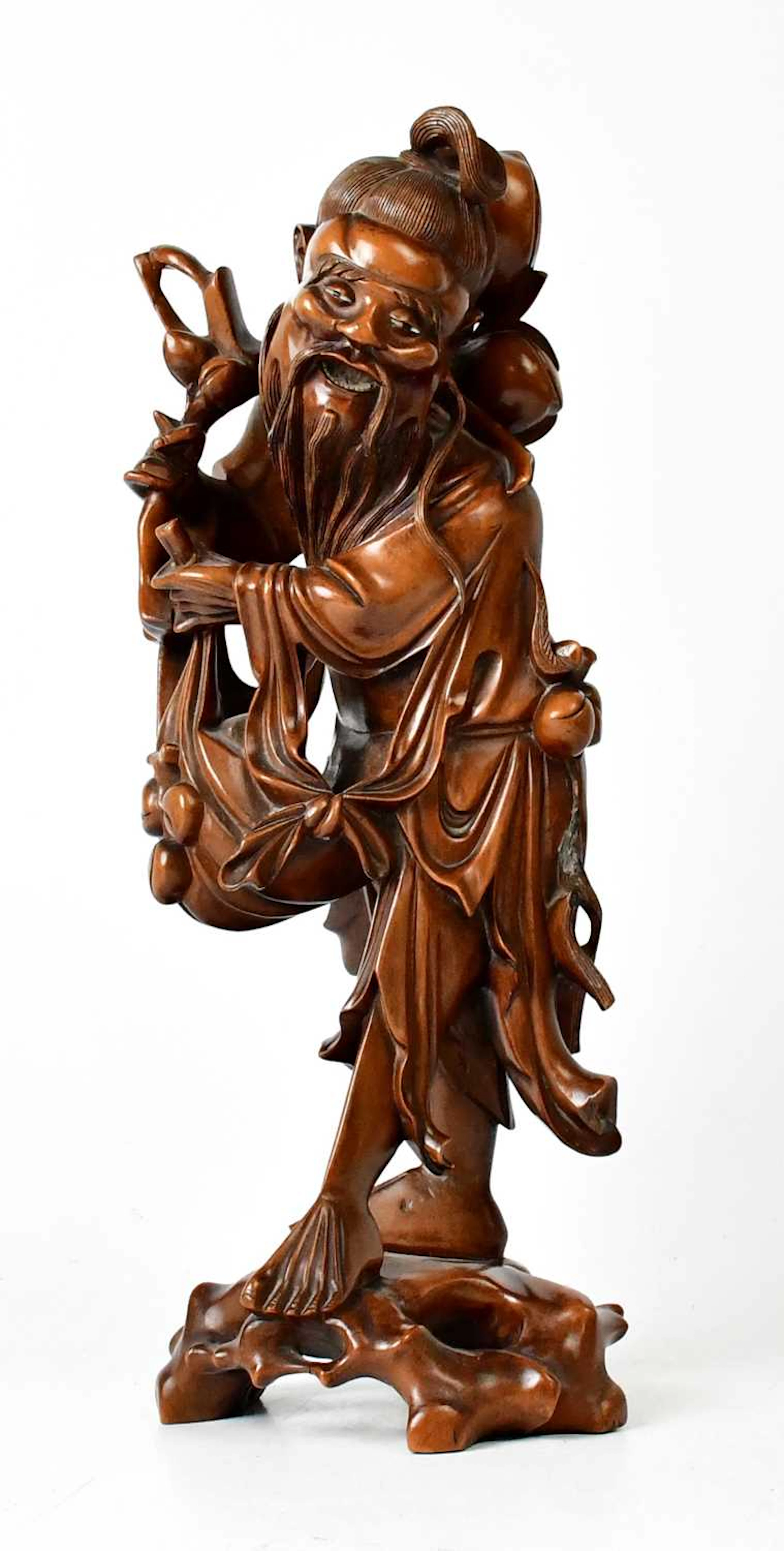 A Japanese carved wooden figure of a man with inset bone eyes