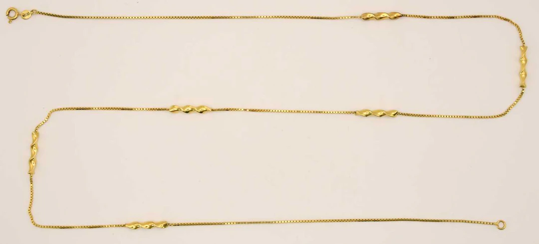 A 9ct bright yellow gold necklace consisting of six twist...