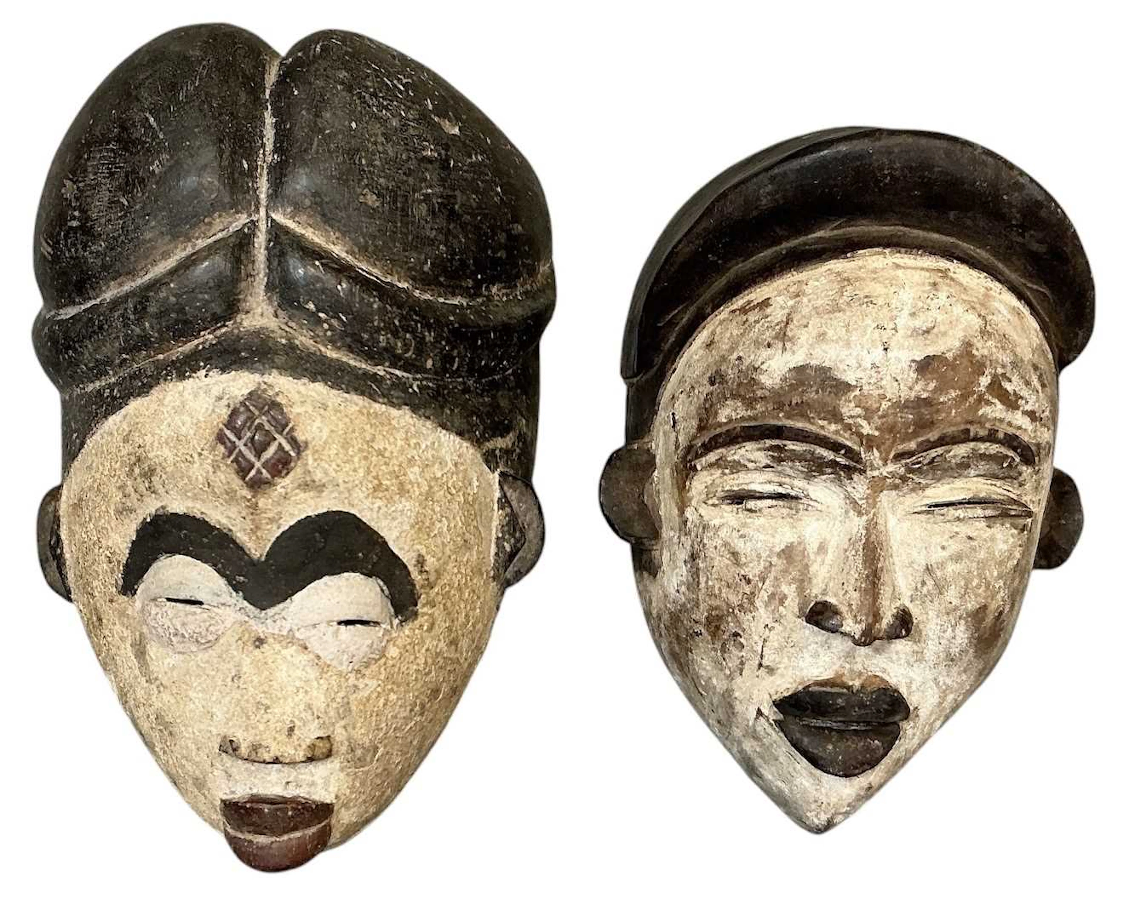 Two African carved wooden tribal painted Punu maiden spirit masks