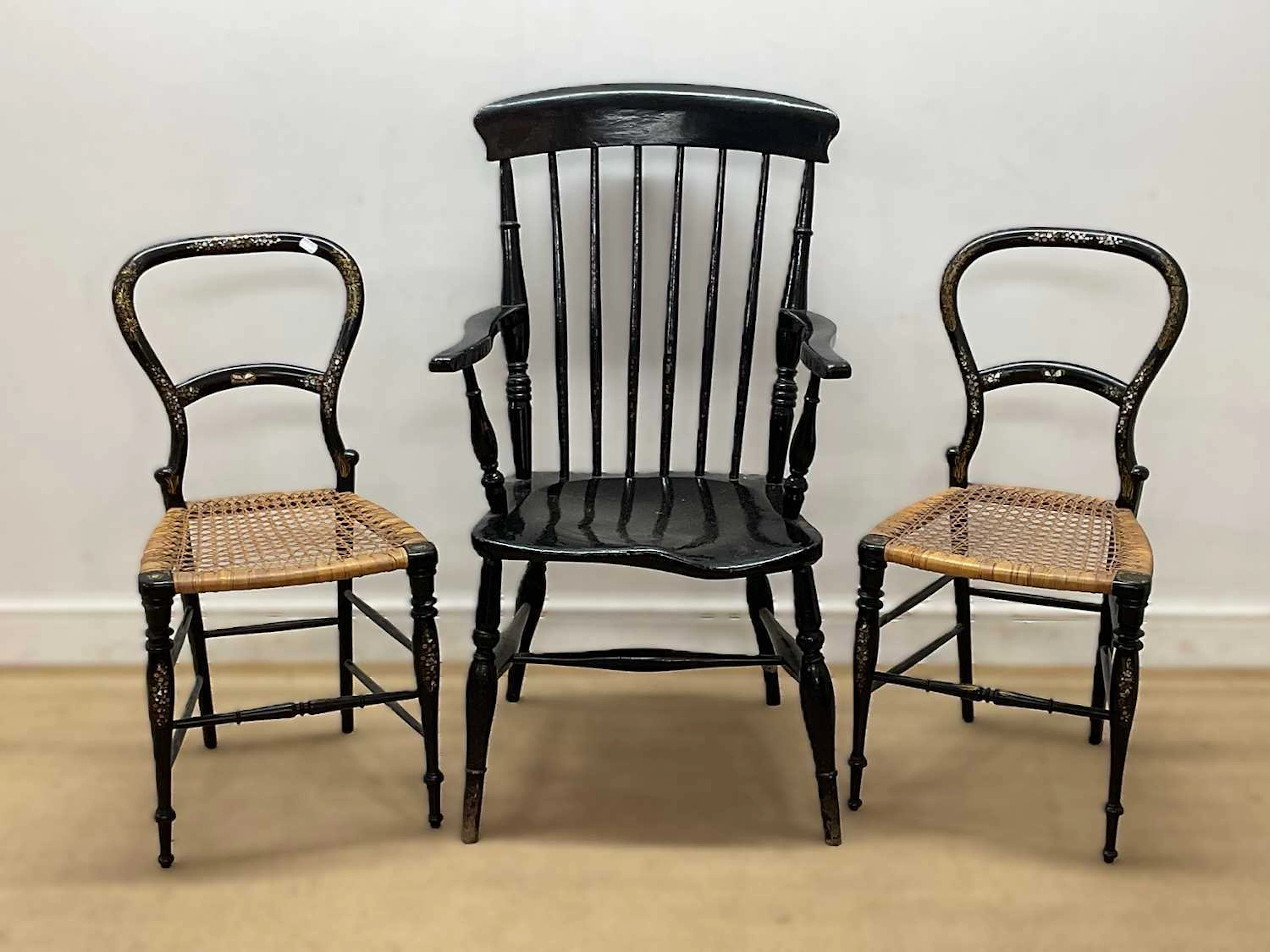 A pair of ebonised side chairs with mother of pearl inlay