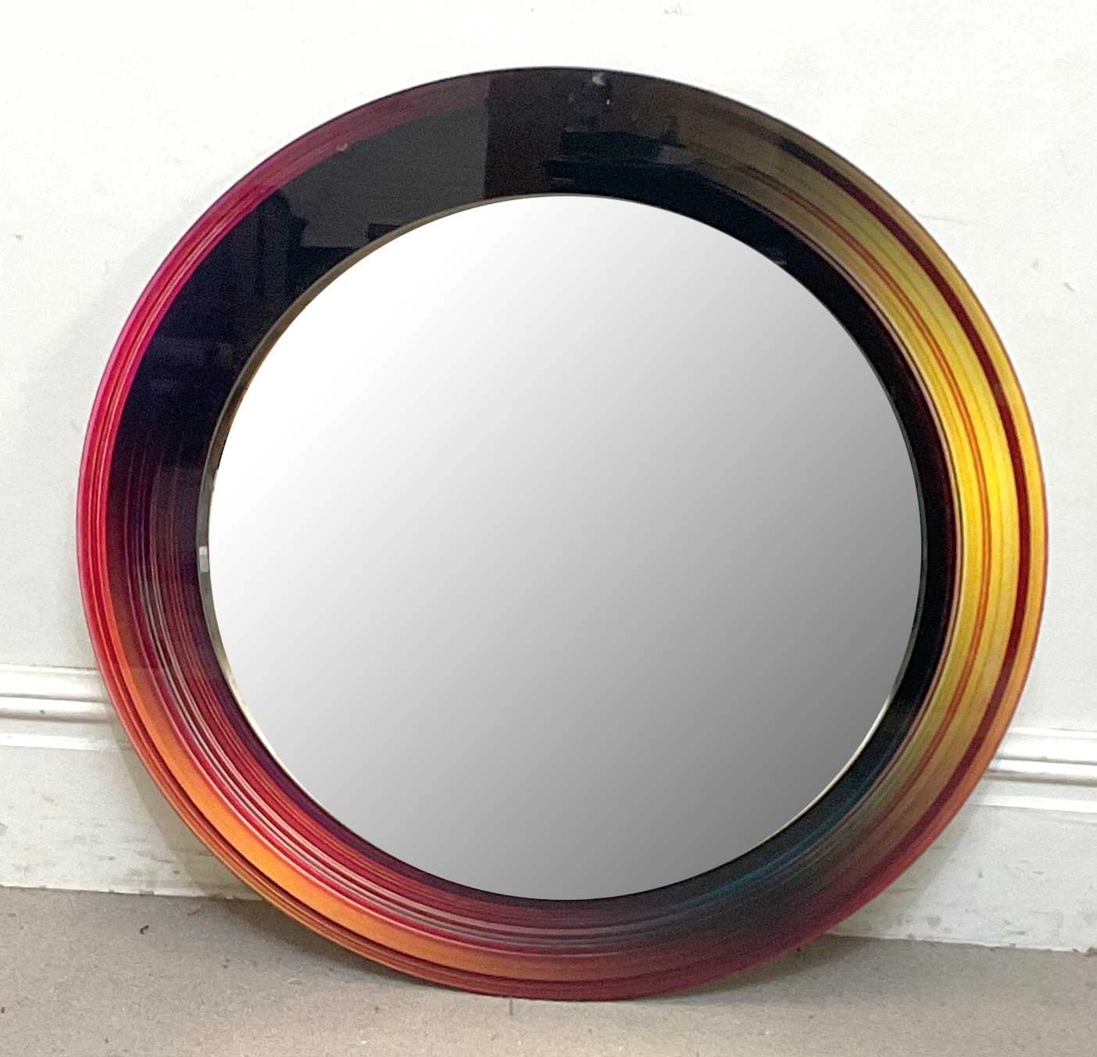 A contemporary art glass wall mirror of circular form...