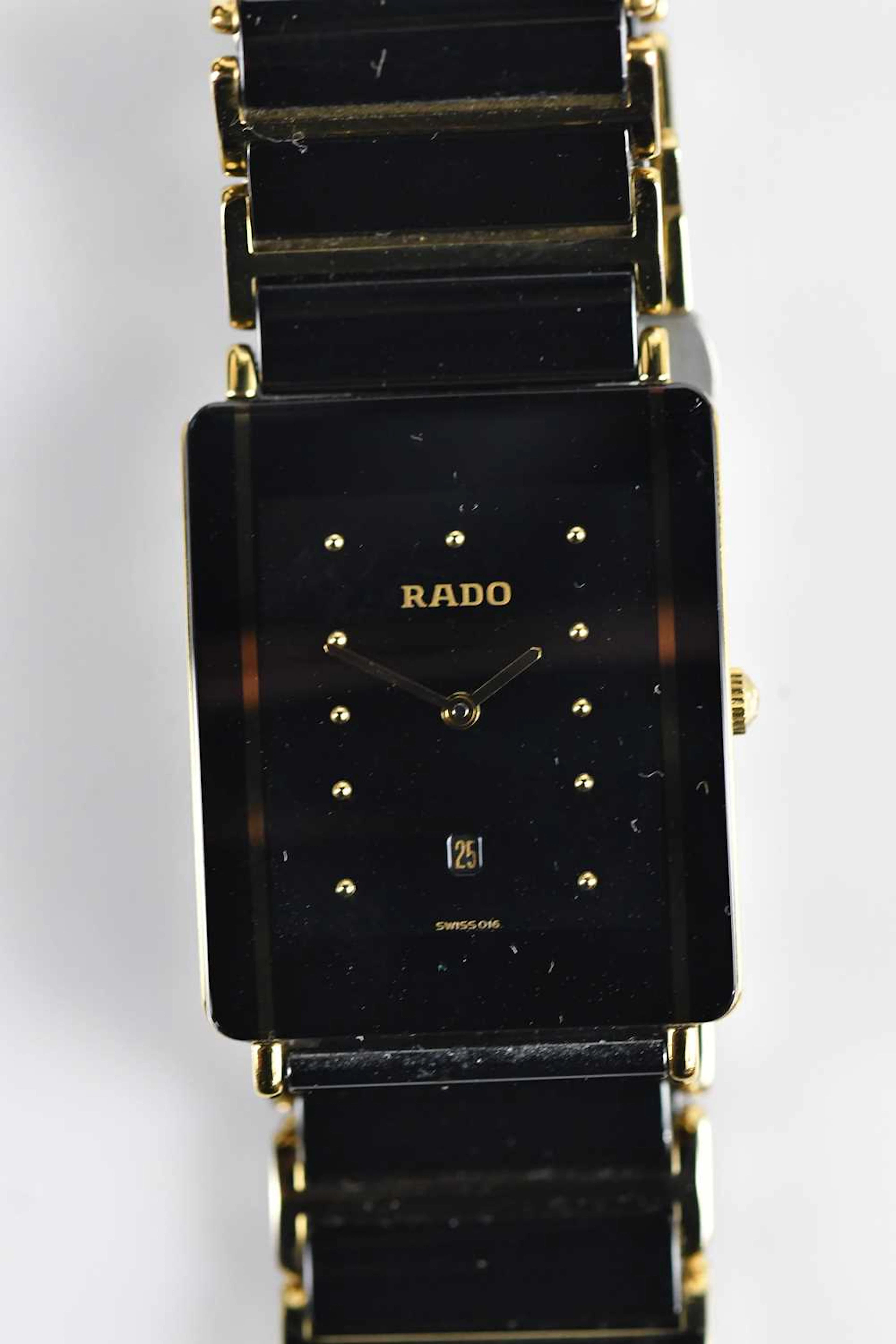 RADO; a gentleman's black ceramic and gold tone bracelet watch