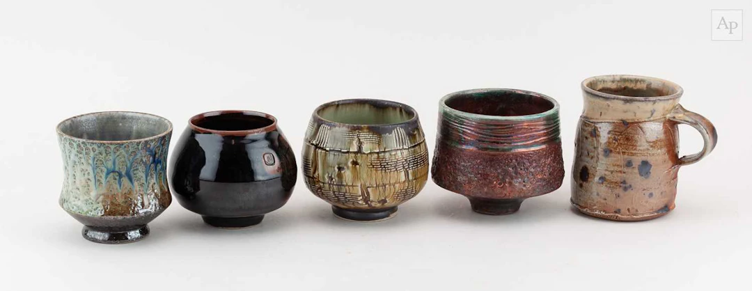 A group of stoneware and raku teabowls by different...