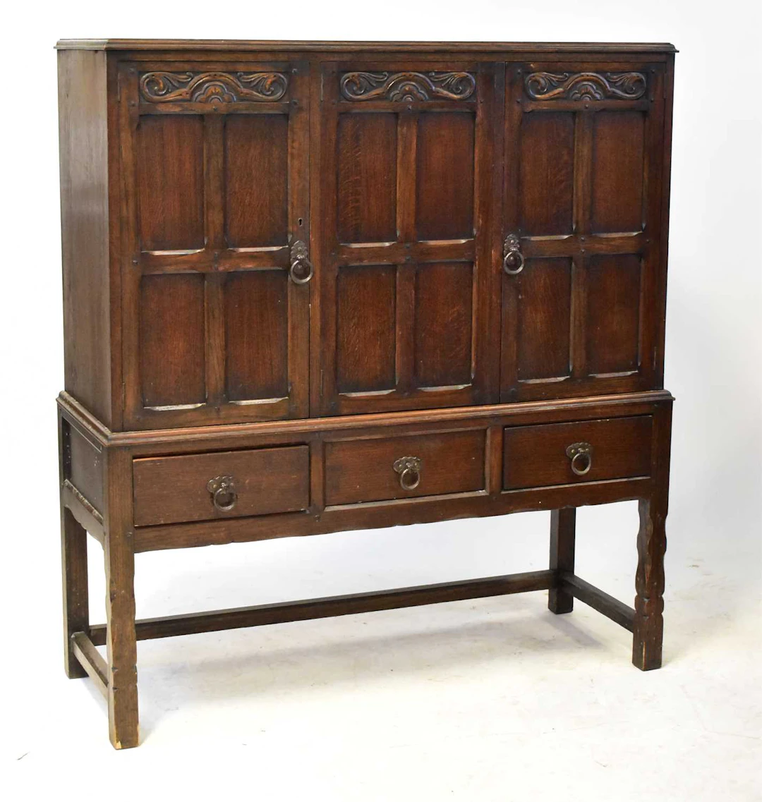 An Old Charm type carved oak cupboard