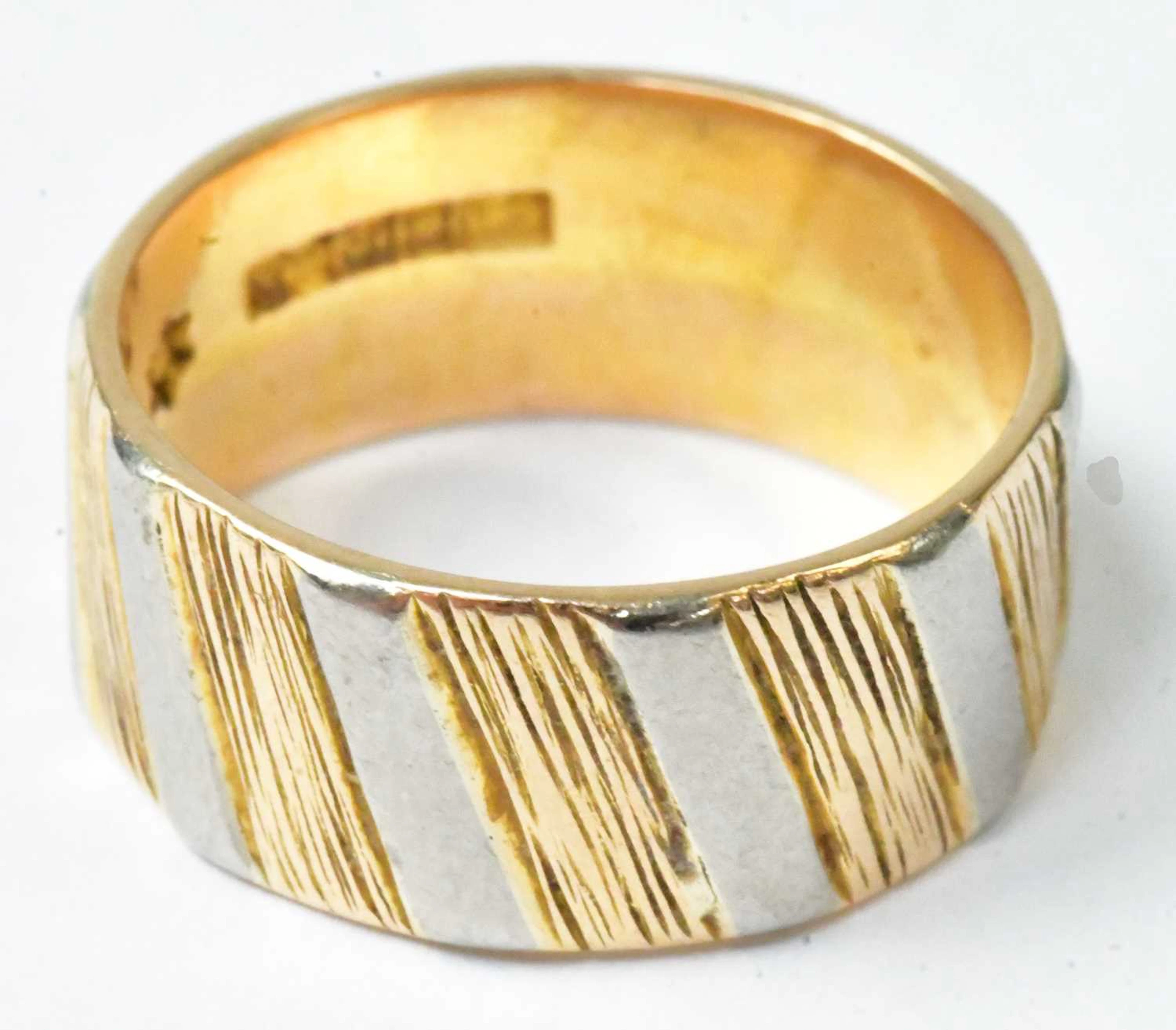 An 18ct yellow and white gold textured ring