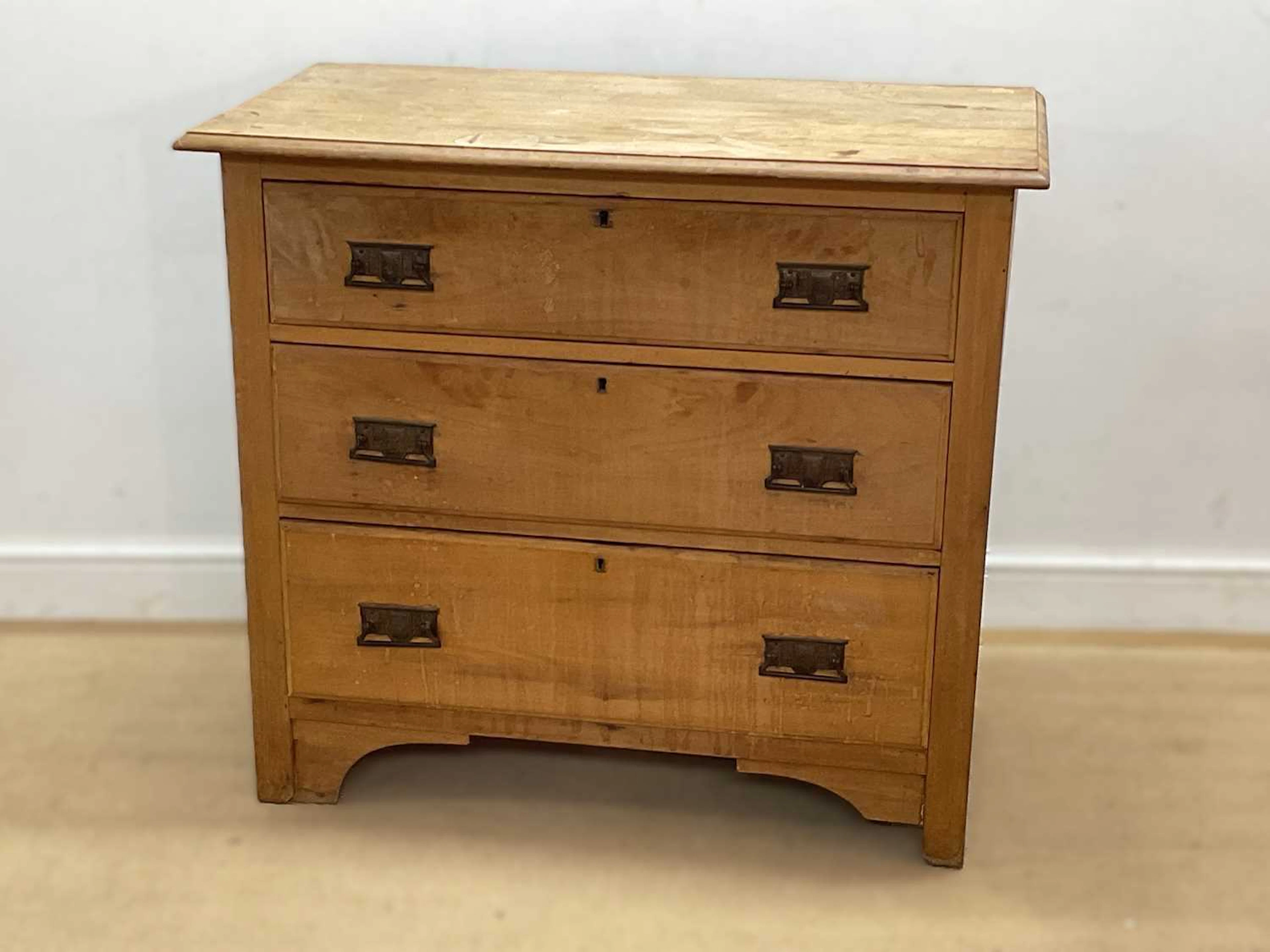 An early 20th century pine chest of three graduated drawers