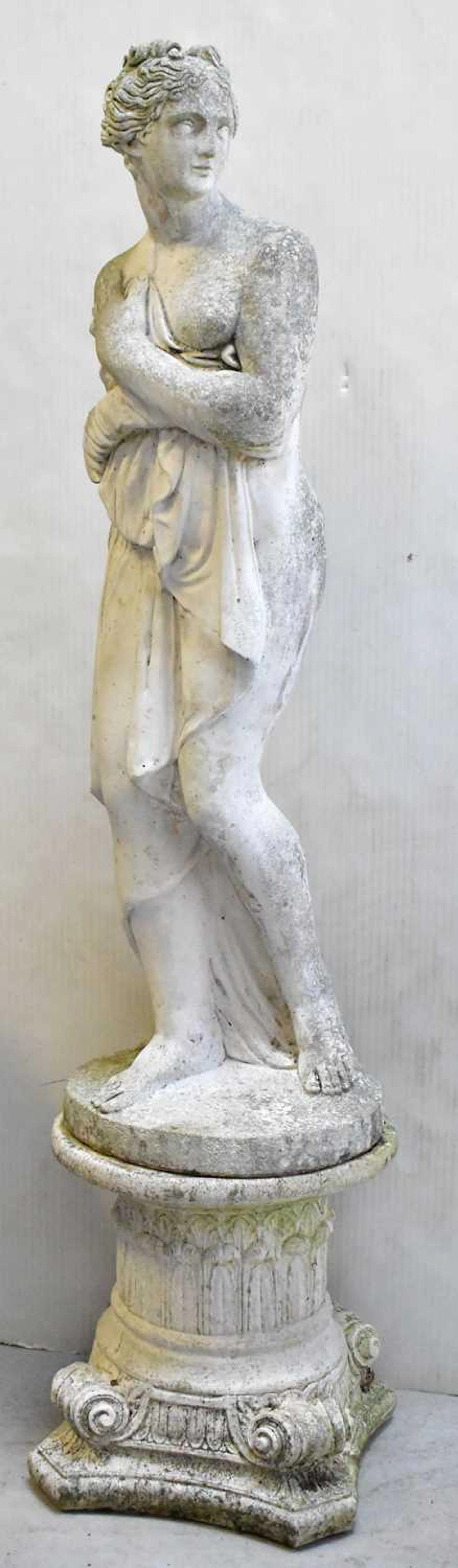 A classical style reconstituted garden statue of a semi-clad lady