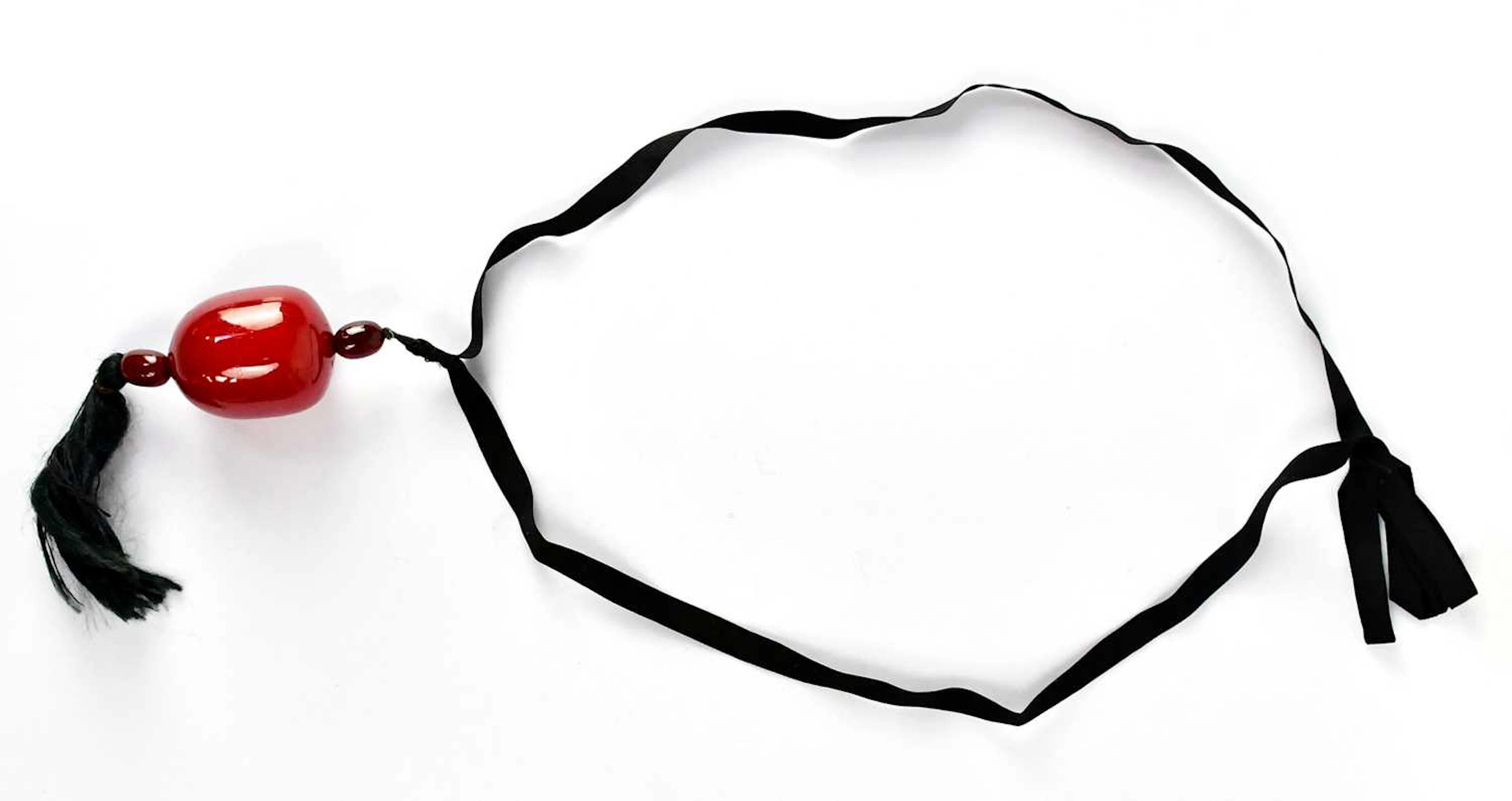 A large cherry amber style pendant comprising three beads