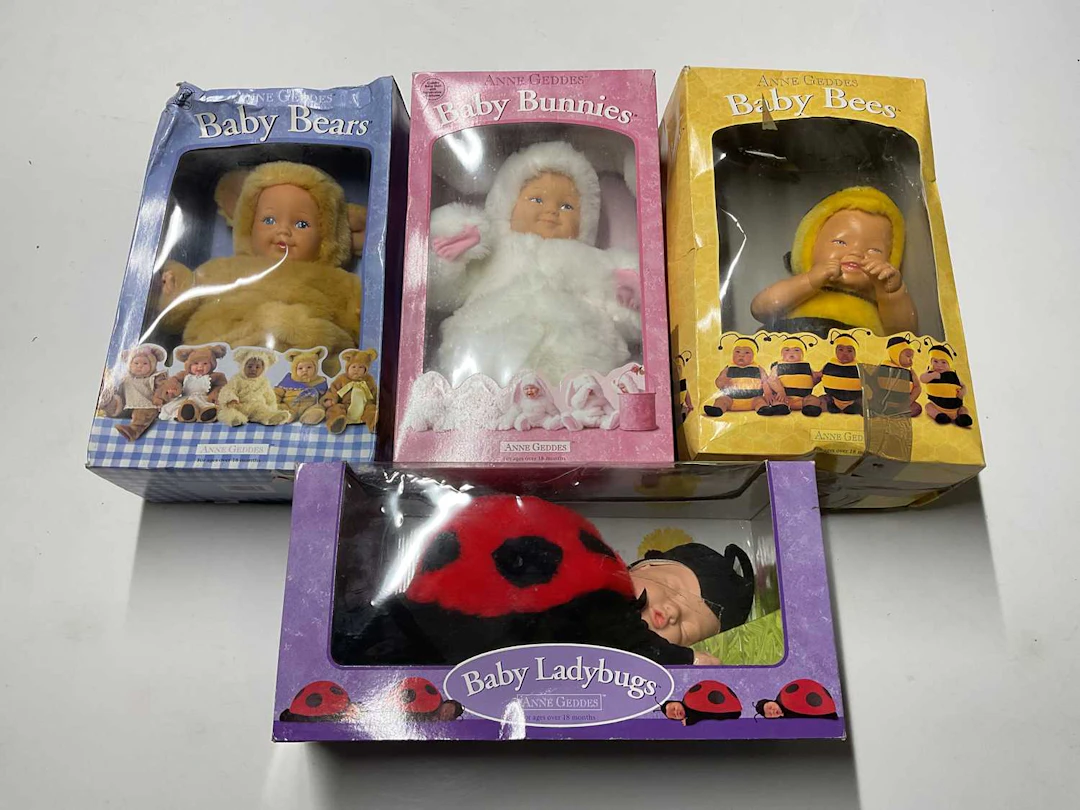 ANNE GEDDES; four collectible baby dolls in a variety of...