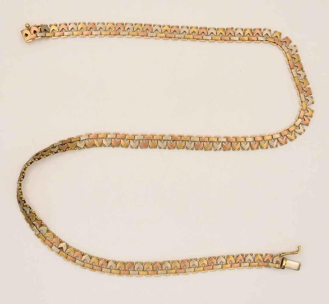 A 9ct three colour gold square/chevron tight link necklace