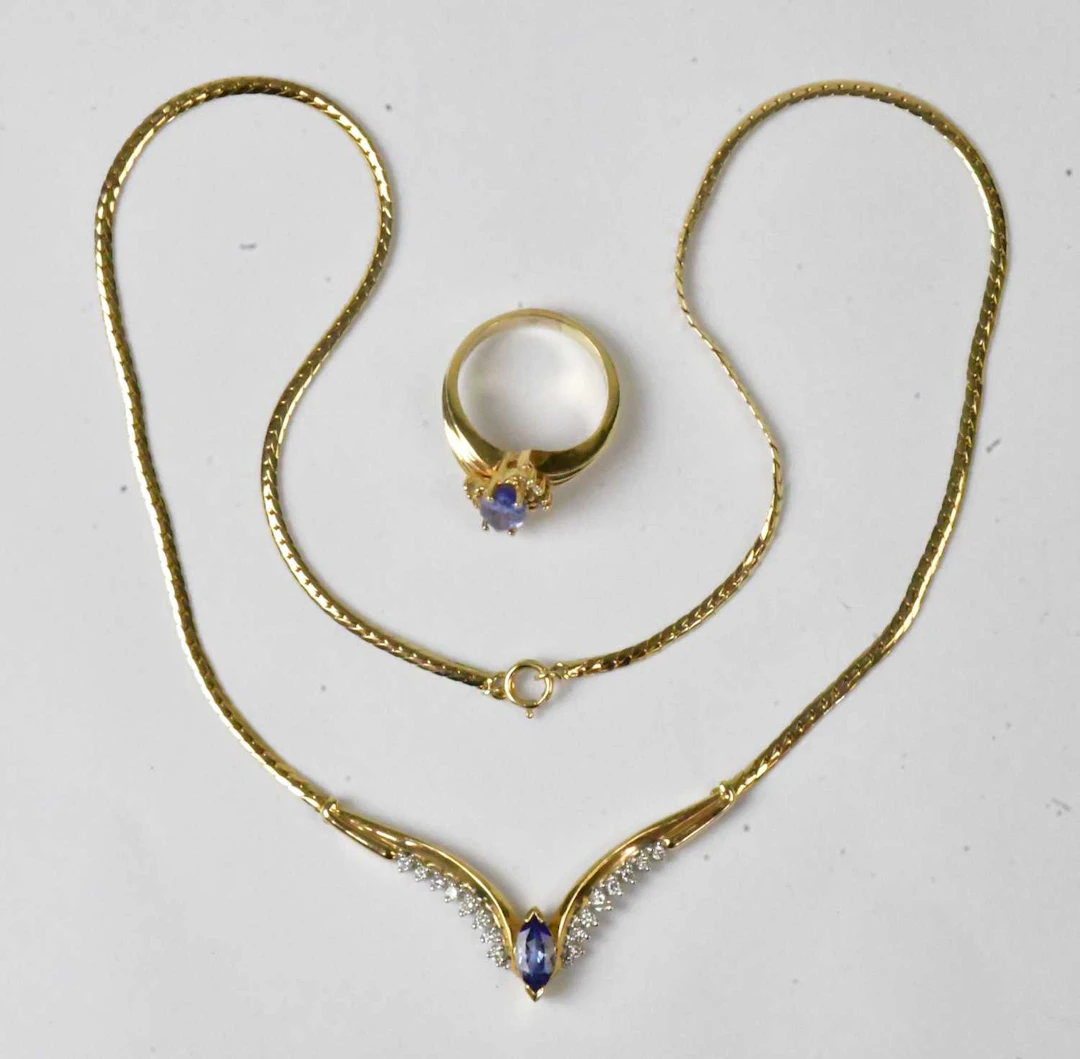 A 14ct yellow gold wishbone-shaped necklace set with a...