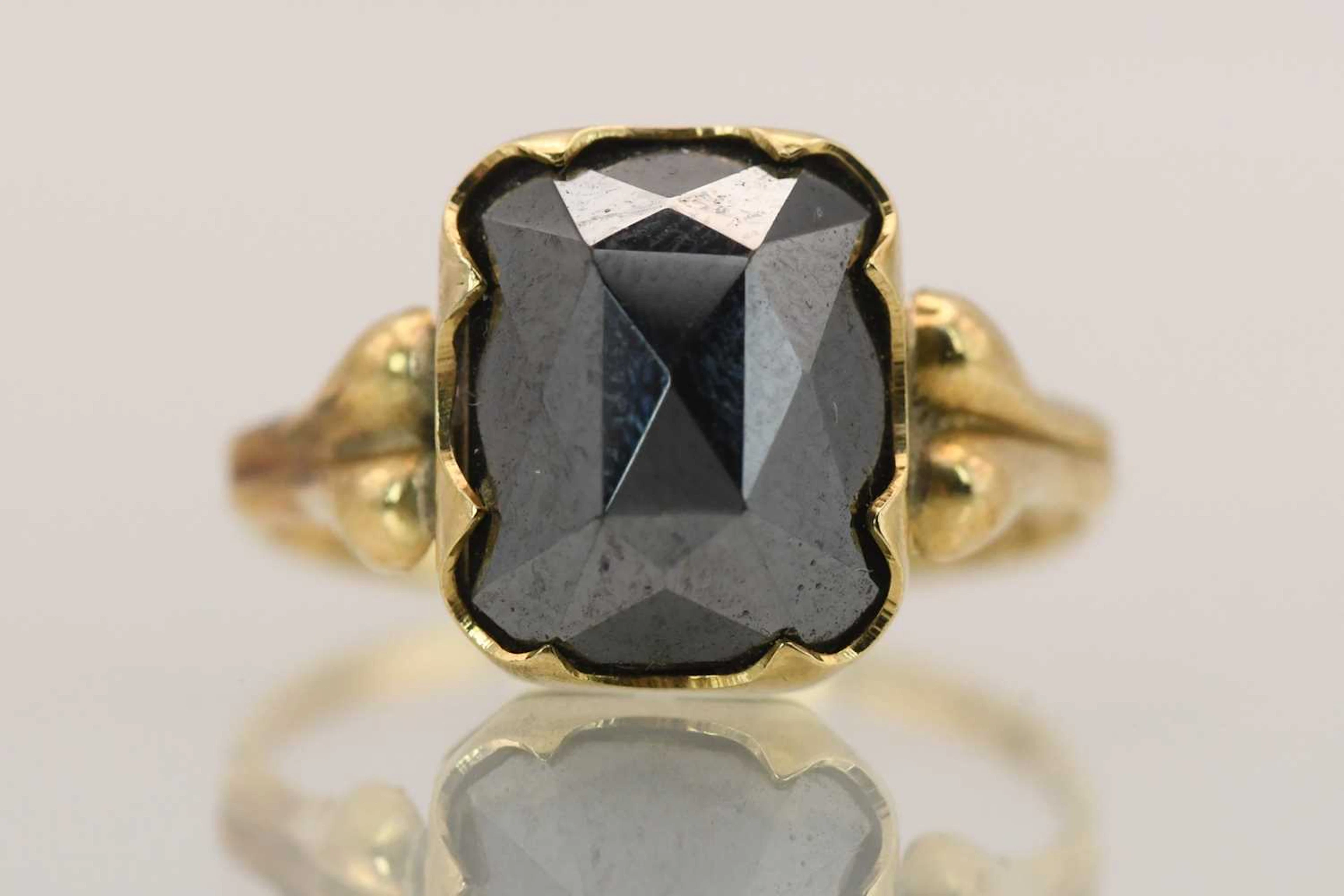 A 14ct yellow gold dress ring with cut hematite set table