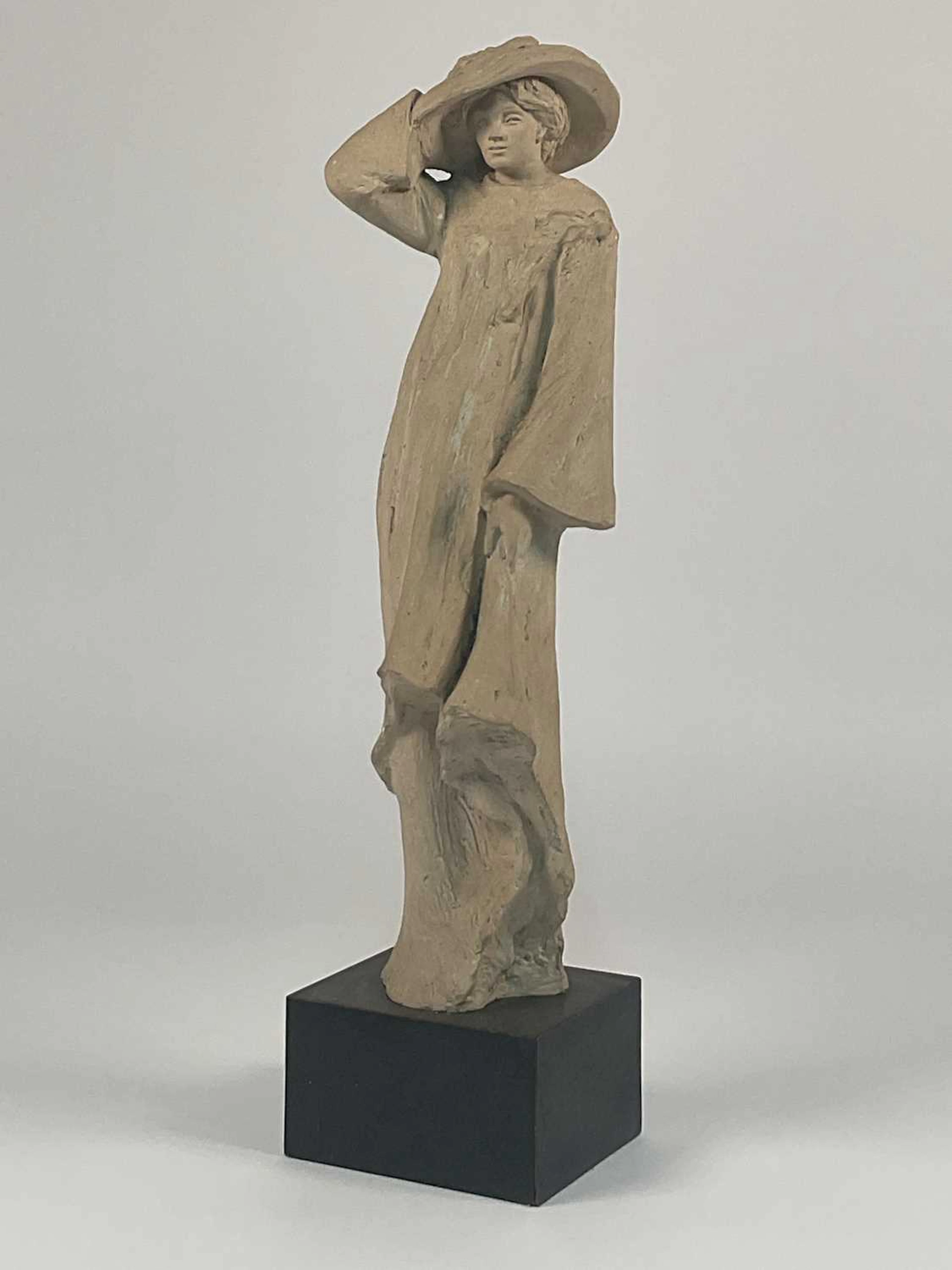 AUSTIN PRODUCTIONS; a plaster sculpture of a woman holding onto her hat