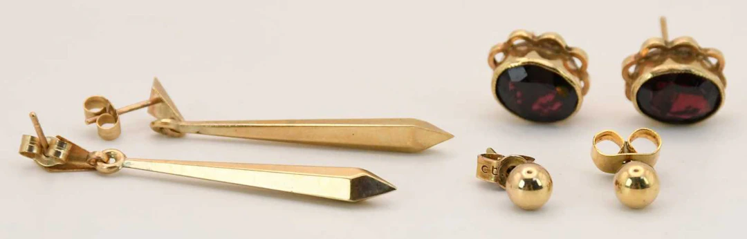 Three pairs of 9ct gold earrings comprising elongated drops