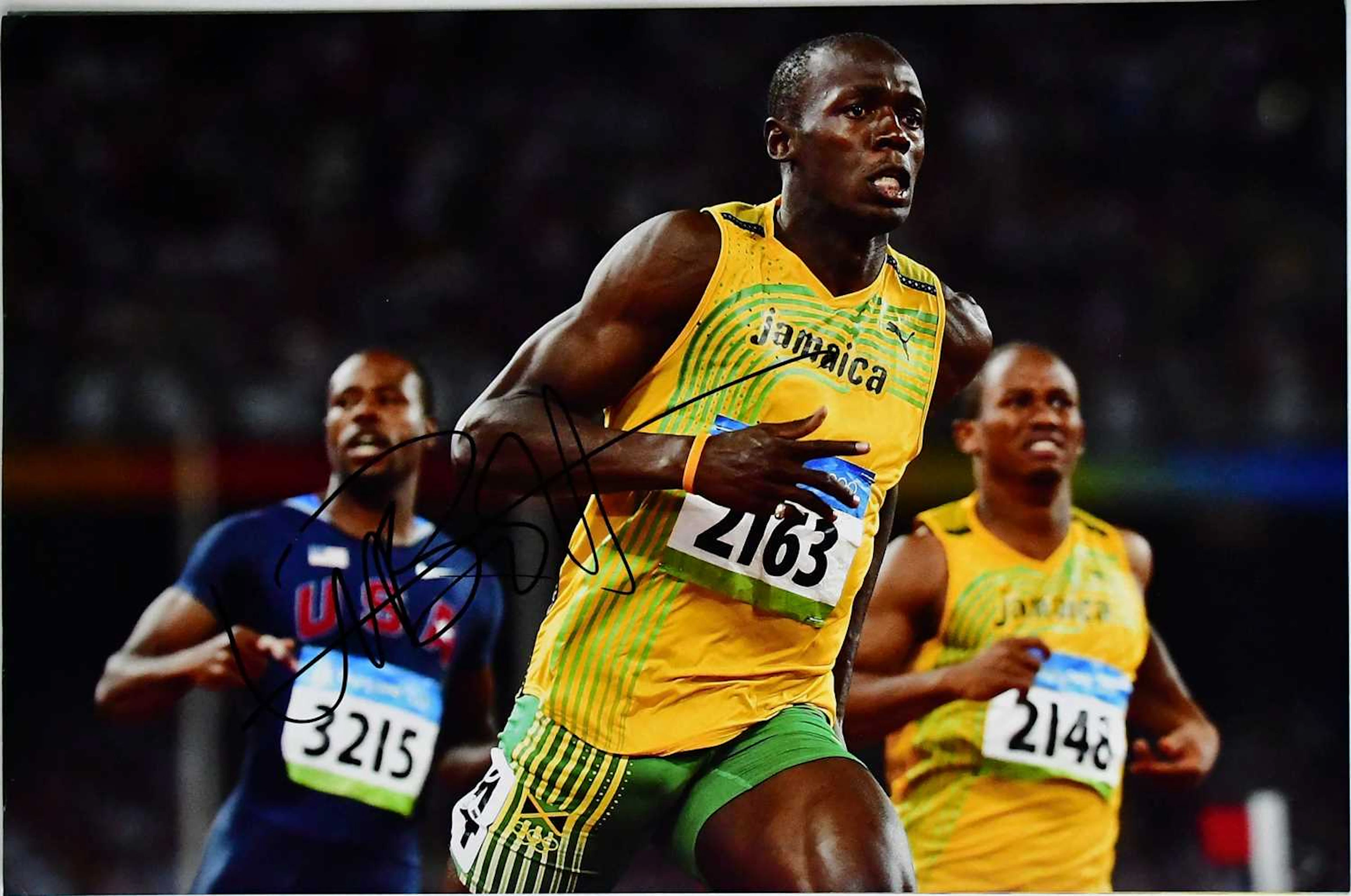USAIN BOLT; three signed colour photographs