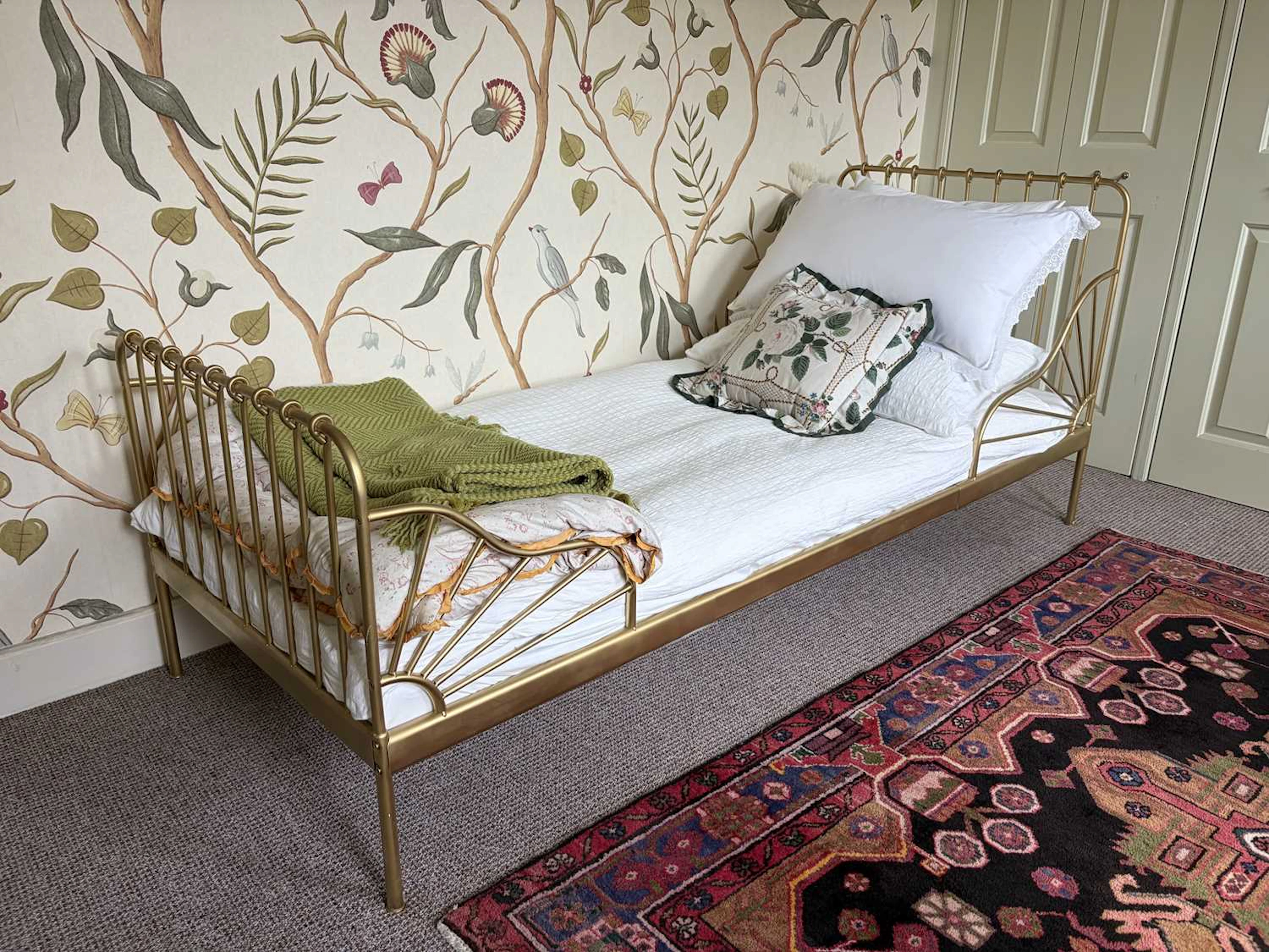 A pair of gilt metal single beds