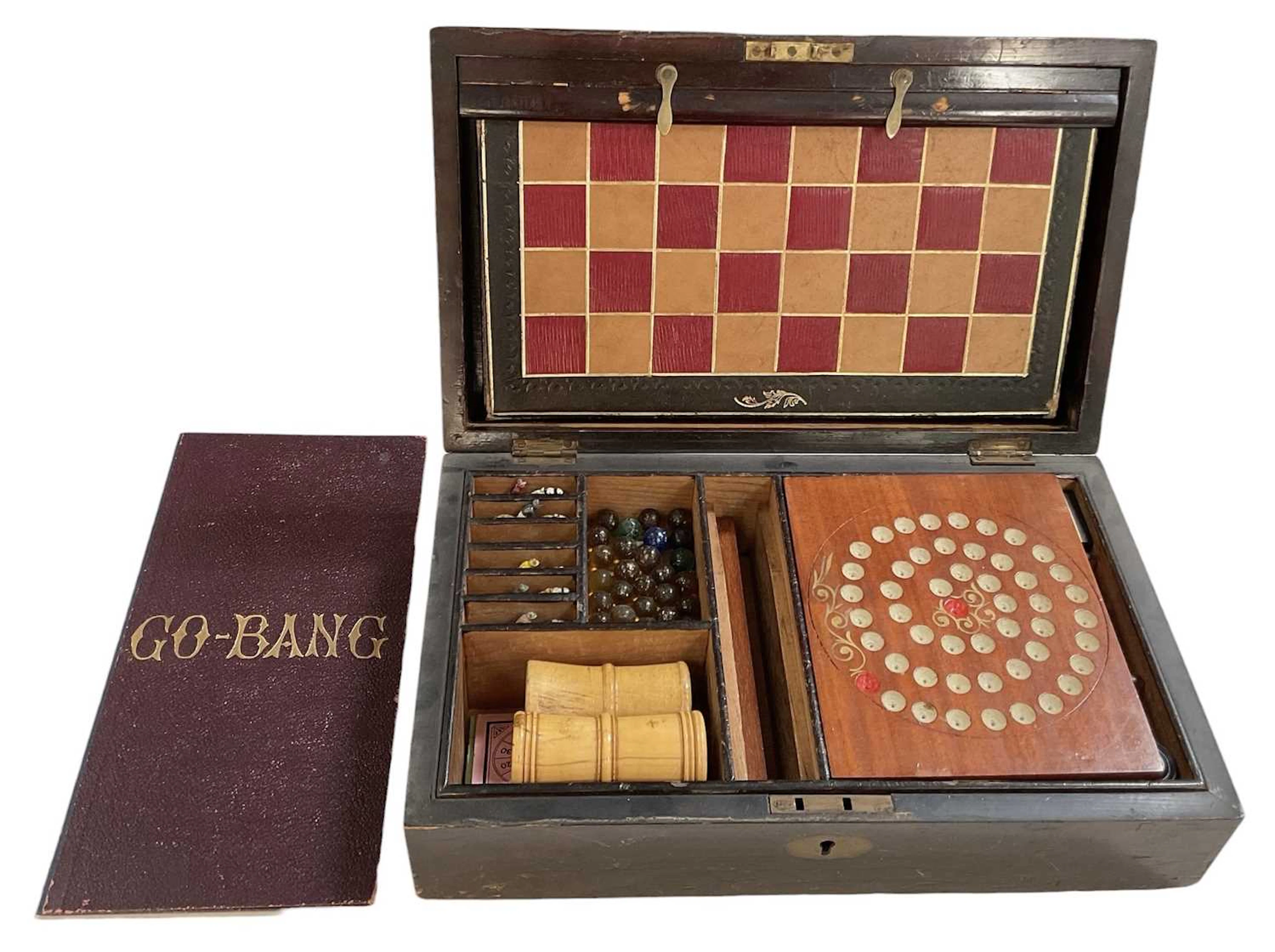 A good Victorian mahogany cased gaming box including counters