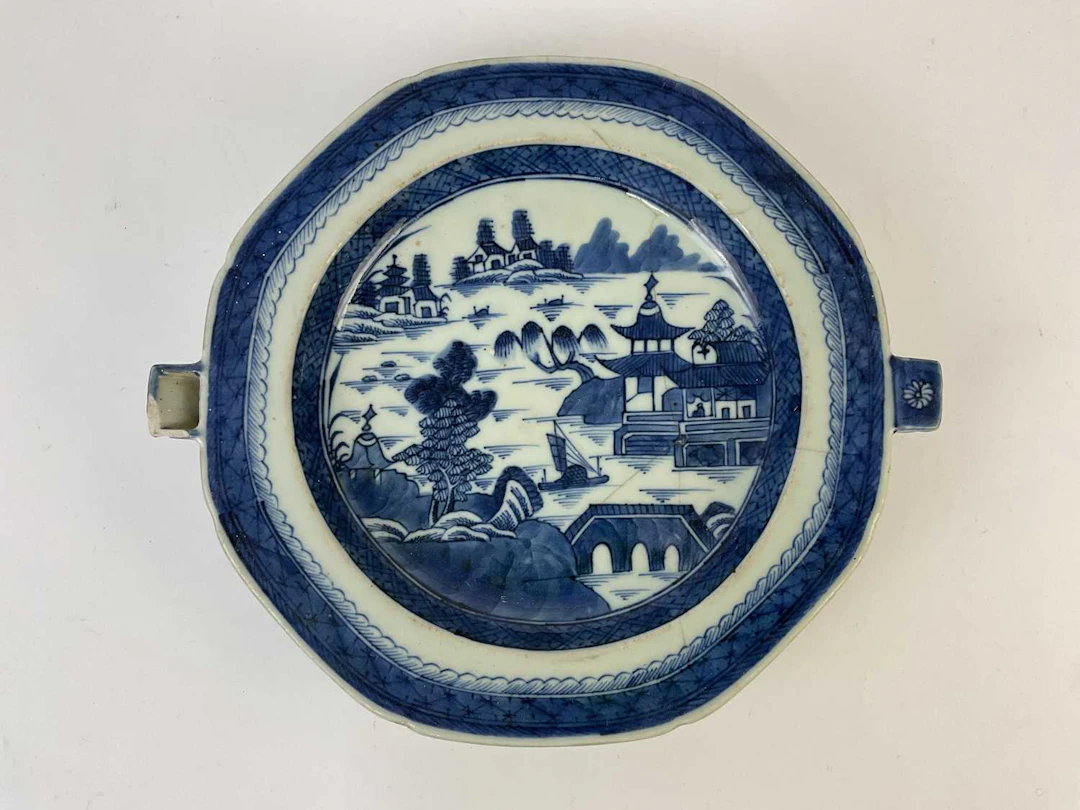 A Chinese porcelain hot water plate decorated with...